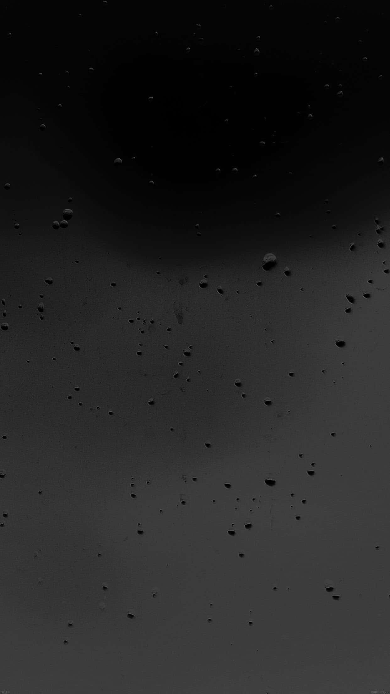霧面黑色 桌布 壁紙 — 暗色單色特寫，雨滴散落在濕玻璃表面上，上方有模糊的圓形陰影。