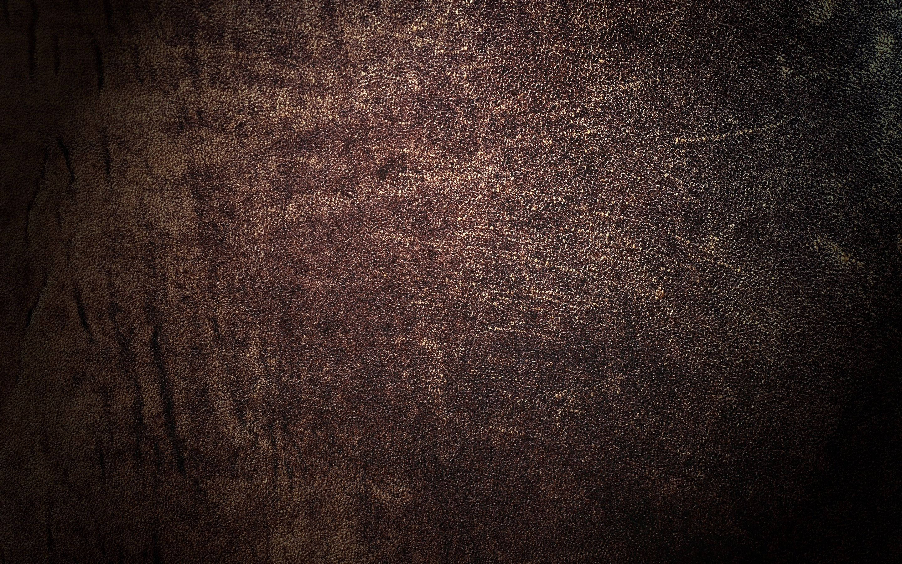 Textured 桌布 壁紙 — 暗色紋理表面的特寫，帶有金色斑點和深色陰影，營造出豐富的金屬光澤。
