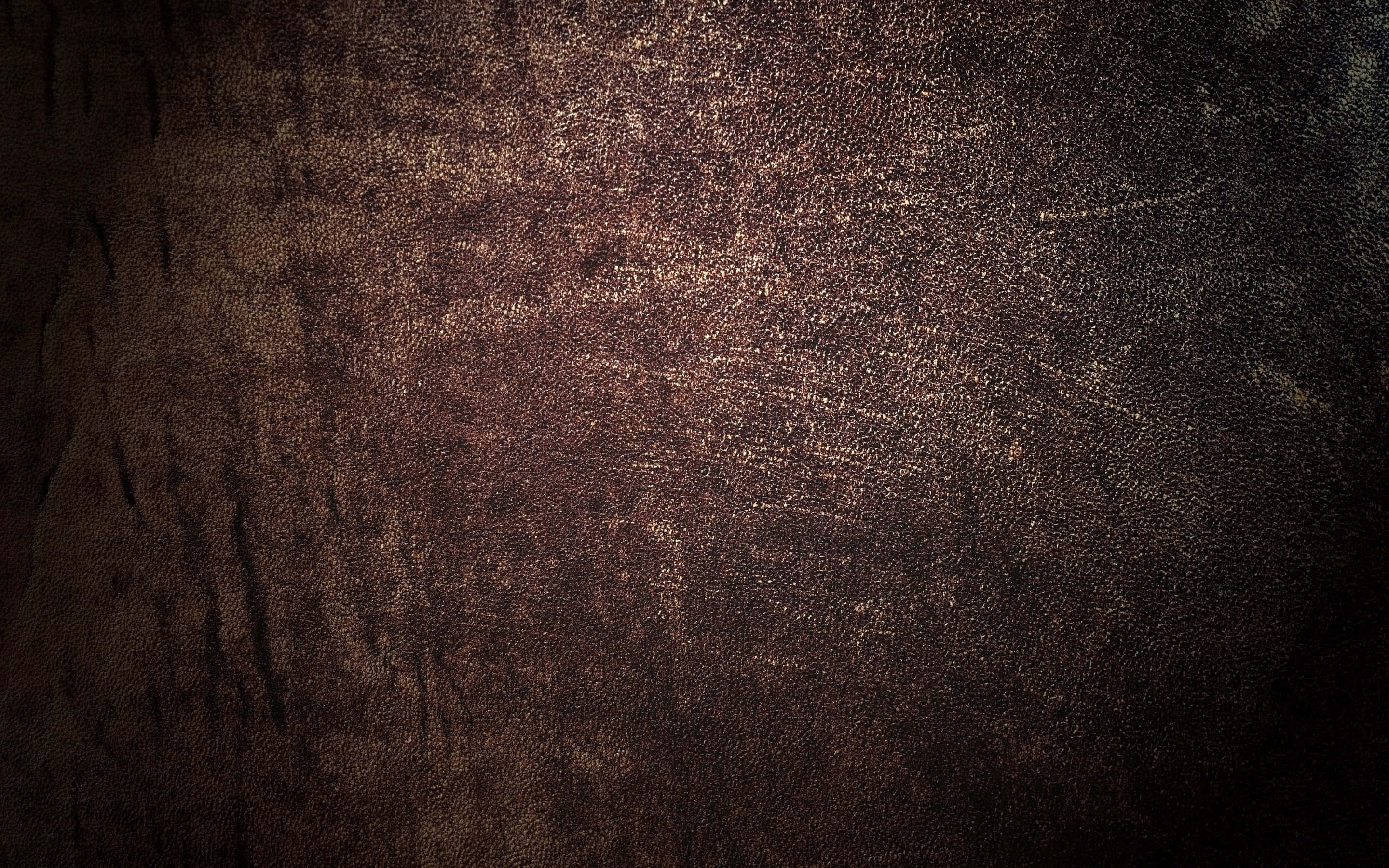 wall 桌布 壁紙 — 暗色紋理表面的特寫，帶有金色斑點和深色陰影，營造出豐富的金屬光澤。