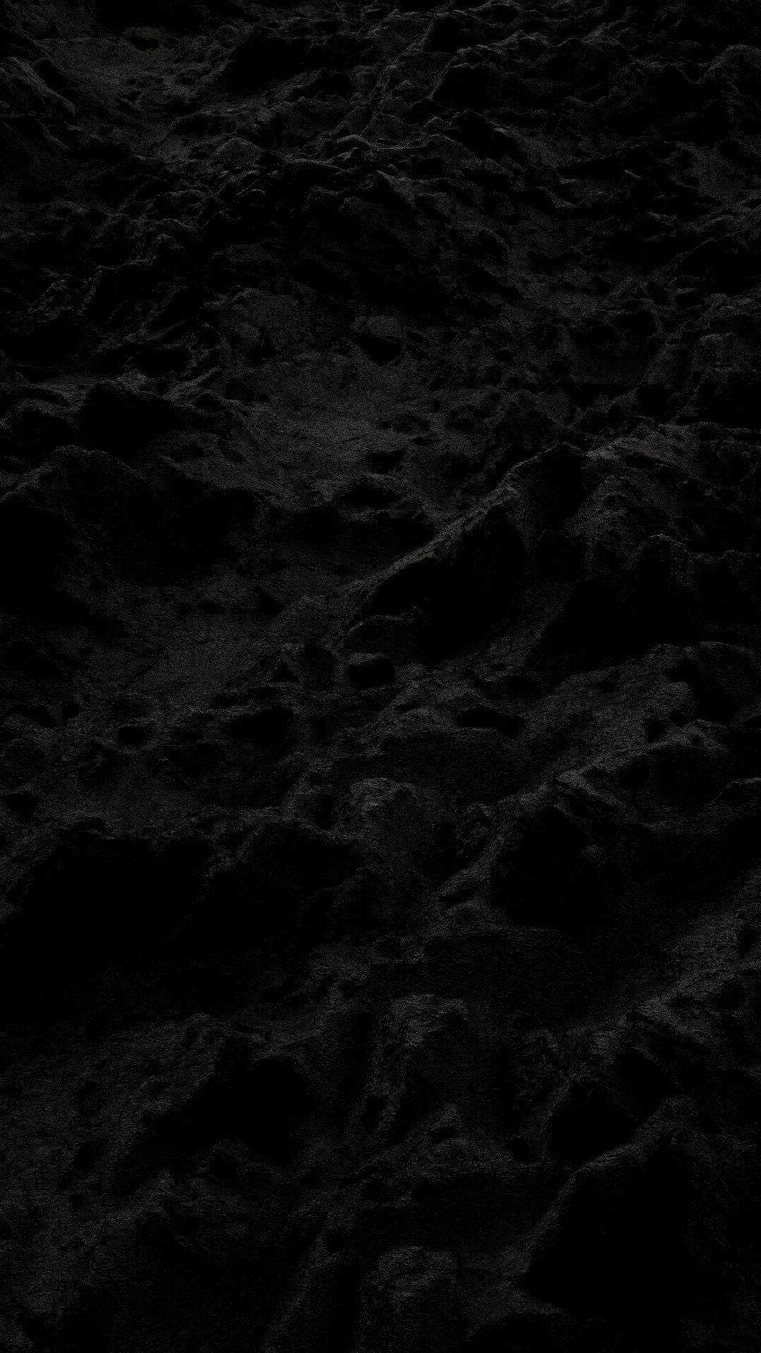 Best Dark 桌布 壁紙 — 暗色紋理表面的特寫，陰影和深度有細微變化。