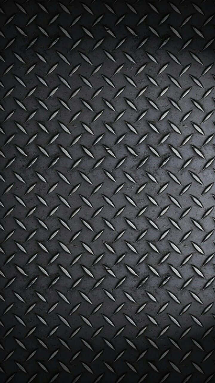 Diamond Plate 桌布 壁紙 — 暗色紋理鑽石板金屬的特寫，帶有微妙的光線反射，營造出堅固的工業表面。