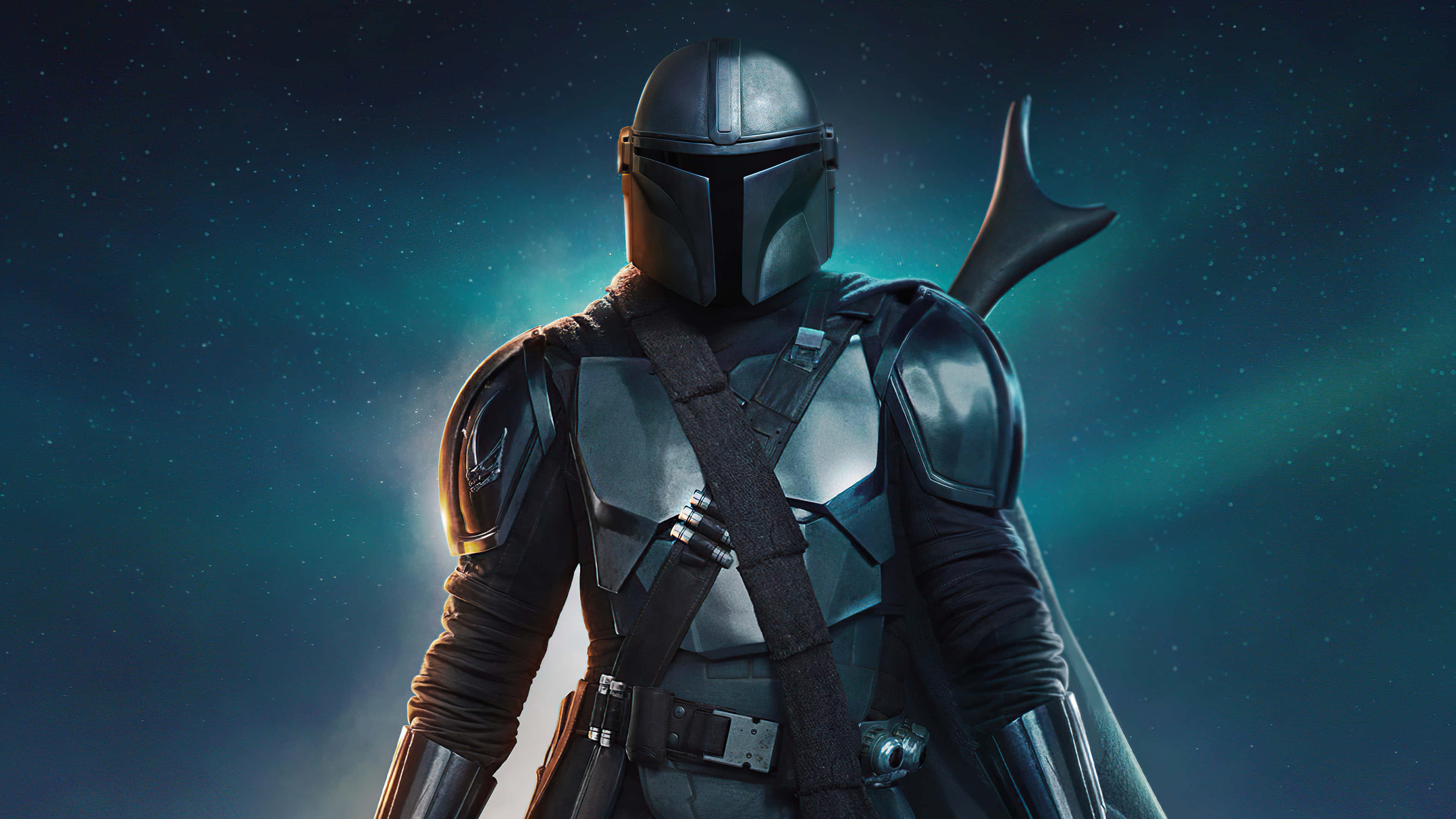 Mandalorian Pc 桌布 壁紙 — 曼達洛人穿著全套盔甲，站在佈滿星星的藍綠色星雲背景前，身後有發光的光線。