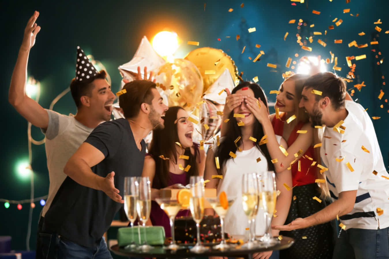 Birthday Celebration 桌布 壁紙 — 朋友們在燈串下的熱鬧夜派對中用五彩紙屑和香檳慶祝。