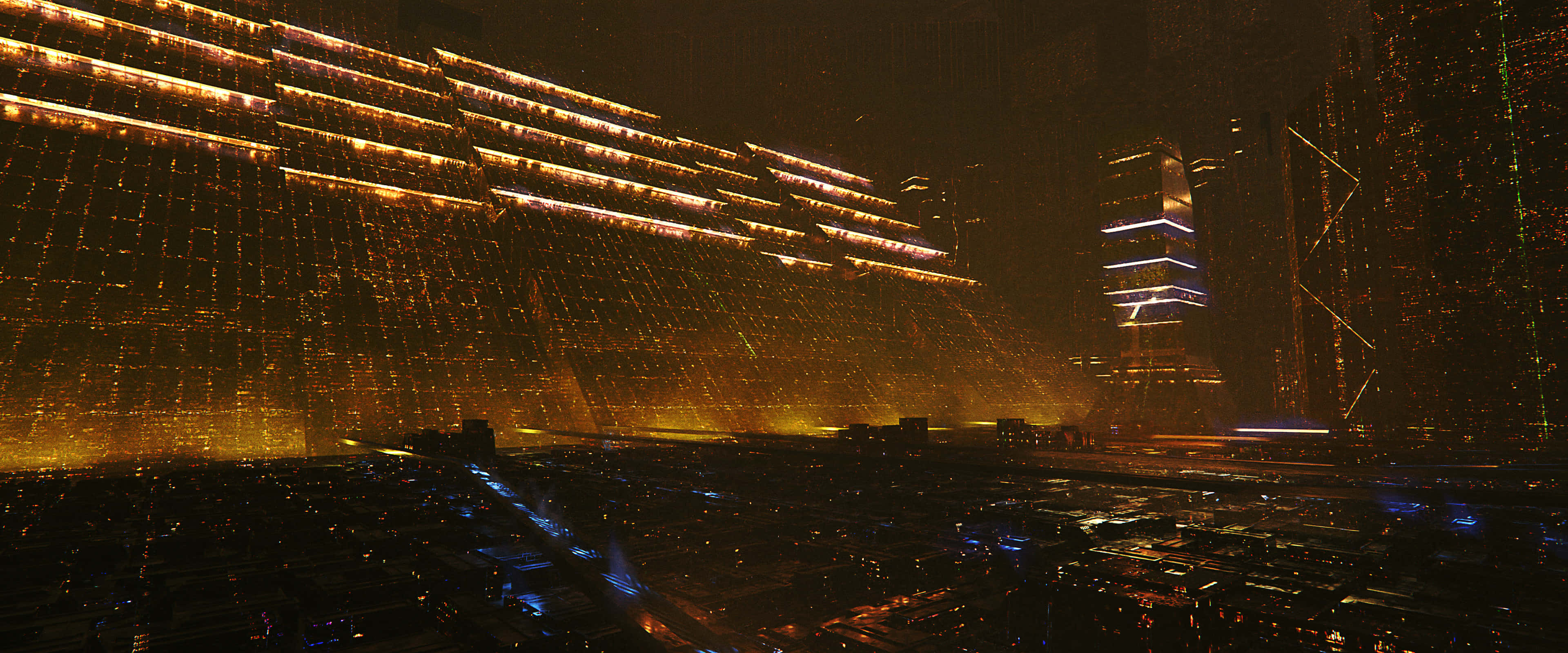 Apple 3840x1600 桌布 壁紙 — 未來主義的城市夜景，高聳的建築物在黑暗的天空下閃耀著金色和藍色的光芒。