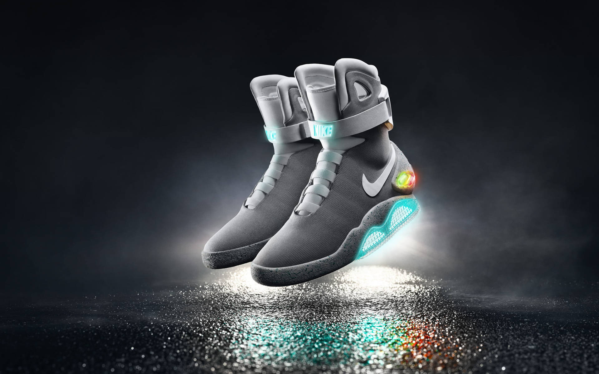 Nike 桌布 壁紙 — 未來感灰色Nike懸浮鞋，帶有發光藍色和彩虹點綴，漂浮在潮濕反光表面上，背景為深色。