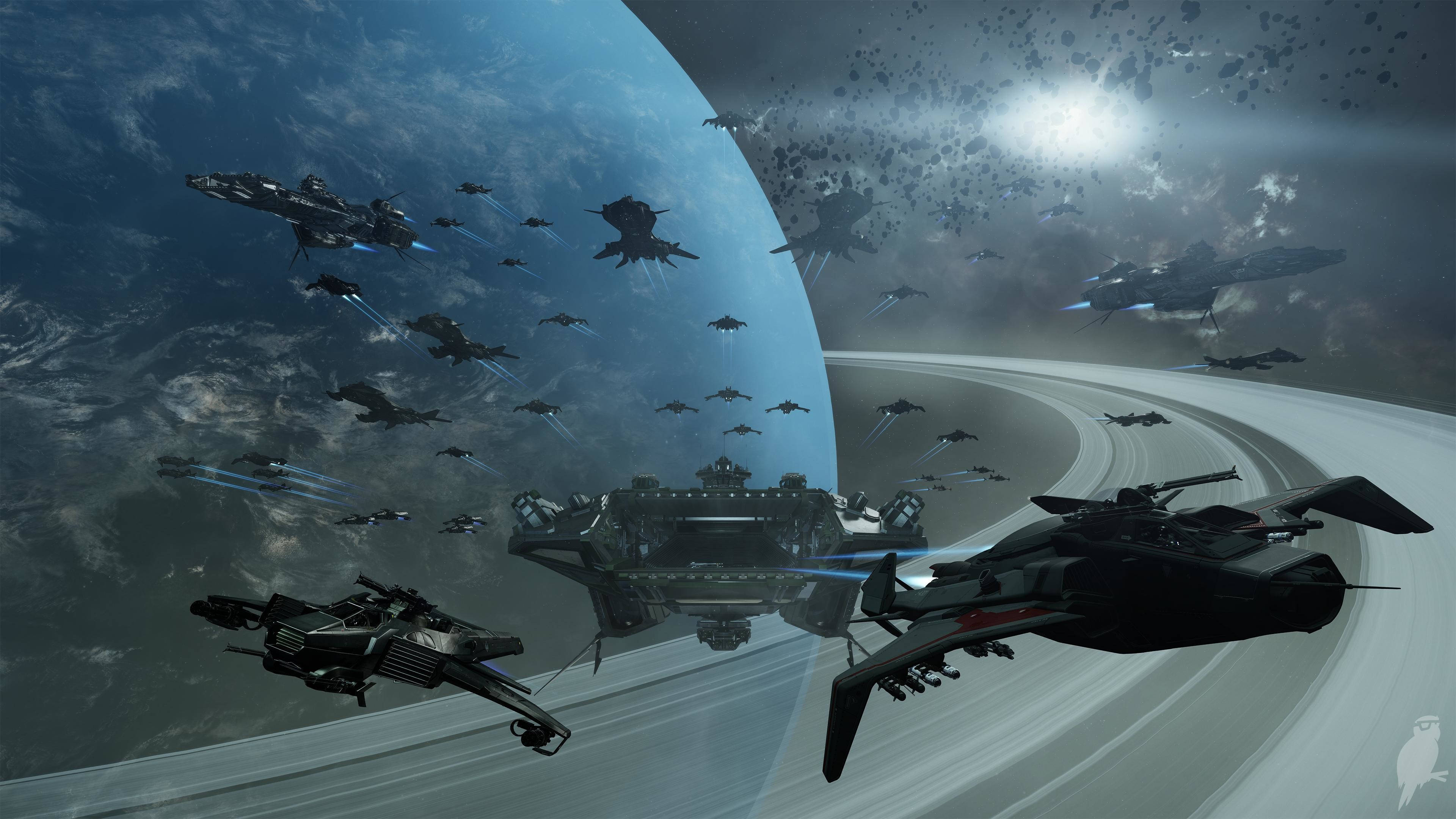 Star Citizen 桌布 壁紙 — 未來戰艦和戰鬥機在太空翱翔，靠近一個帶有光環的行星，明亮的太陽投射出戲劇性的光芒。