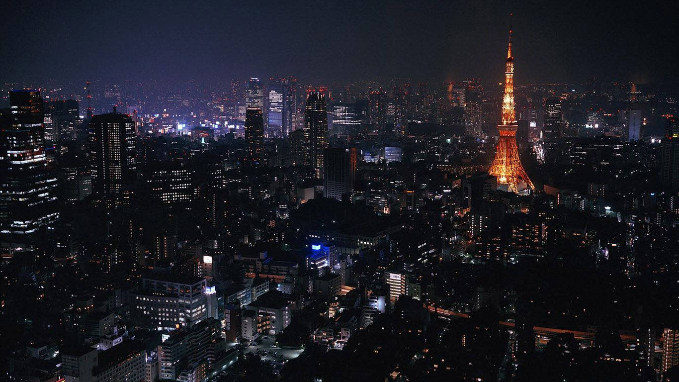 東京 桌布 壁紙 — 東京天際線的夜間鳥瞰圖，被明亮照亮的東京塔在閃爍的摩天大樓海洋中佔據主導地位。