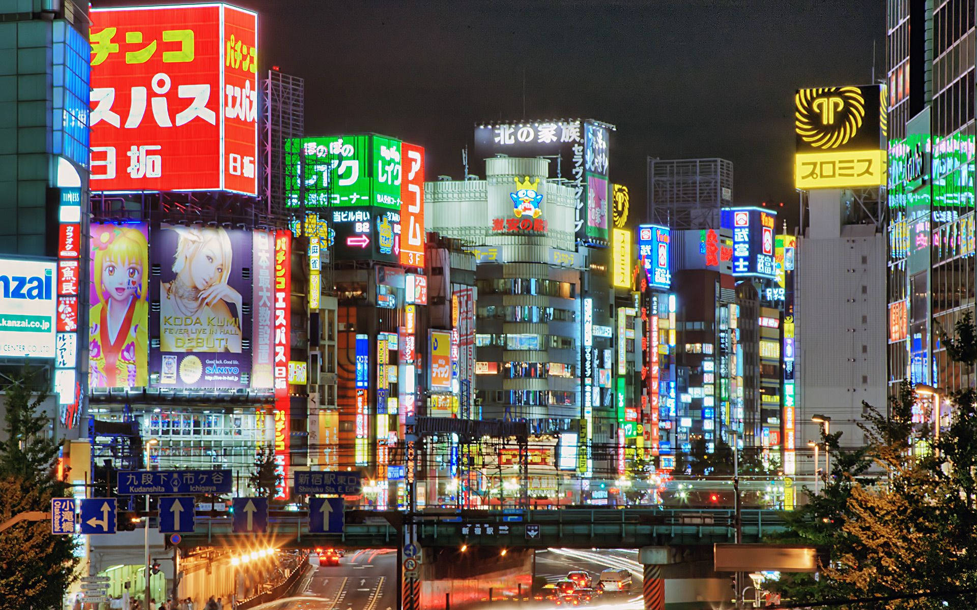 東京 桌布 壁紙 — 東京霓虹燈照亮街道、高聳建築物和閃爍廣告牌的迷人夜景。