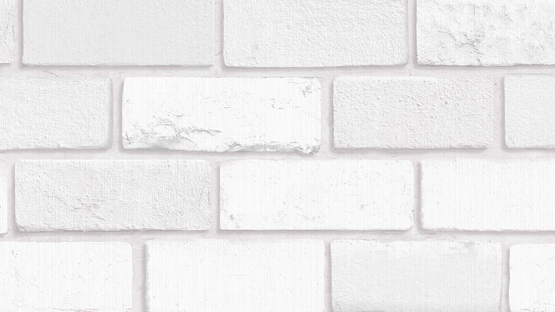 White Brick Wall 桌布 壁紙 — 柔和光線下潔白磚牆的特寫，帶有細微紋理和砂漿線。