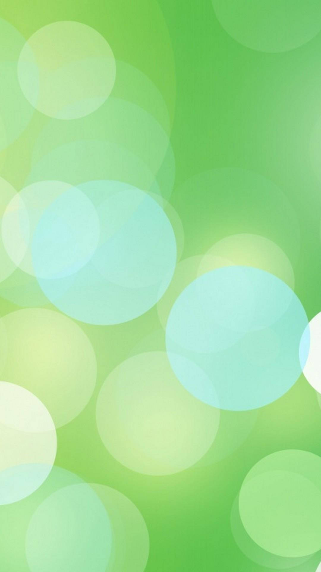 Bokeh 桌布 壁紙 — 柔和發光的圓圈漂浮在漸變綠色背景上，營造出夢幻般的抽象效果。