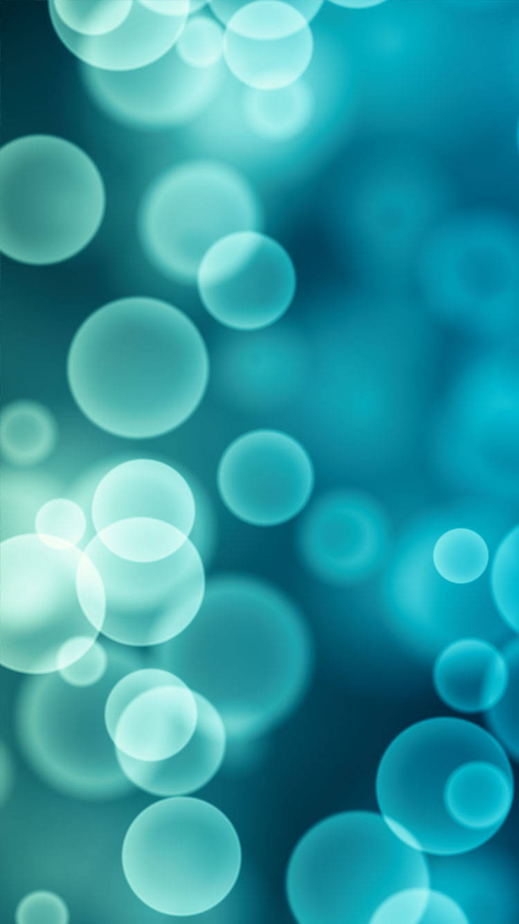 Bokeh 桌布 壁紙 — 柔和發光的青綠色散景圓圈漂浮在夢幻漸變背景中。