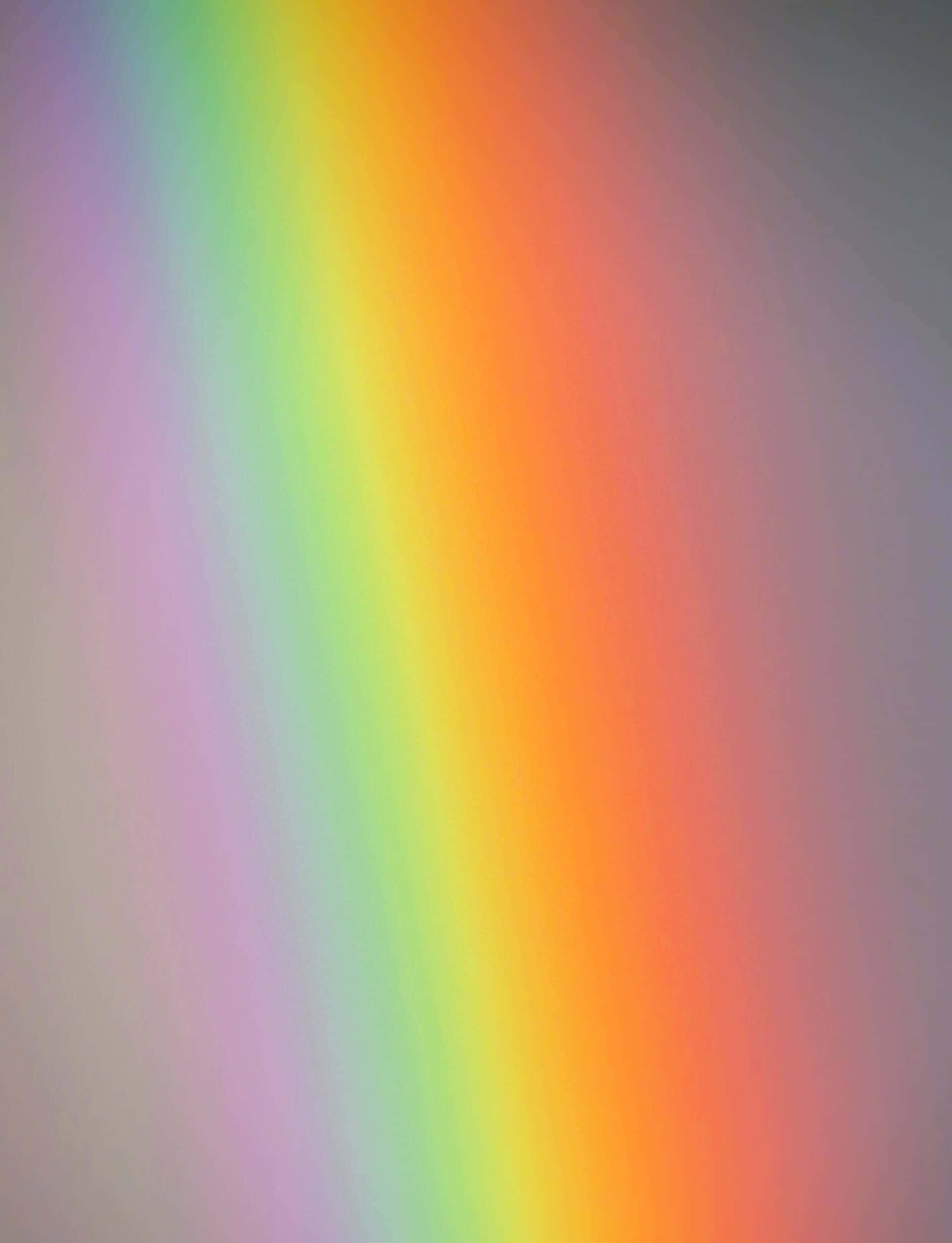 Rainbow Gradient 桌布 壁紙 — 柔和的對角彩虹漸變，從紫色漸變到橙色，背景為柔和的灰色。