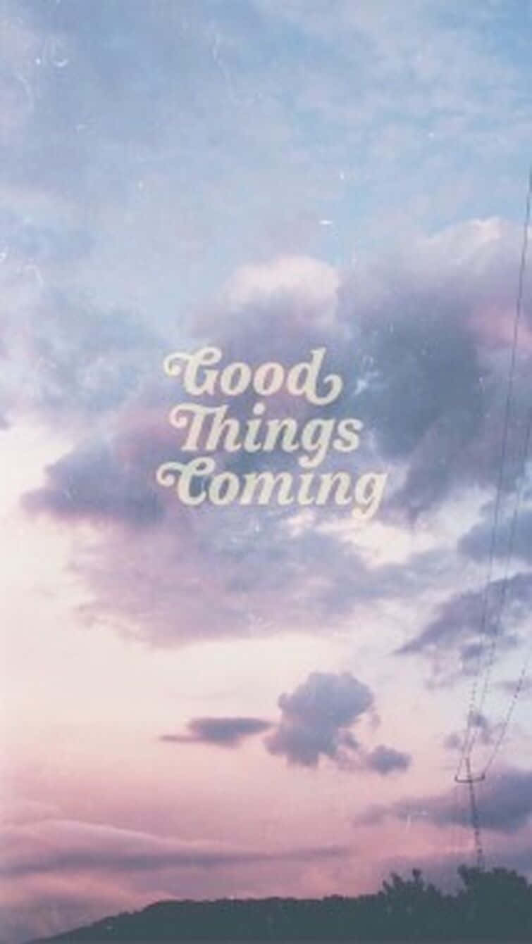 Good Things Are Coming 桌布 壁紙 — 柔和的粉彩天空，有雲和文字 Good Things Coming 在暮色中越過遠山。