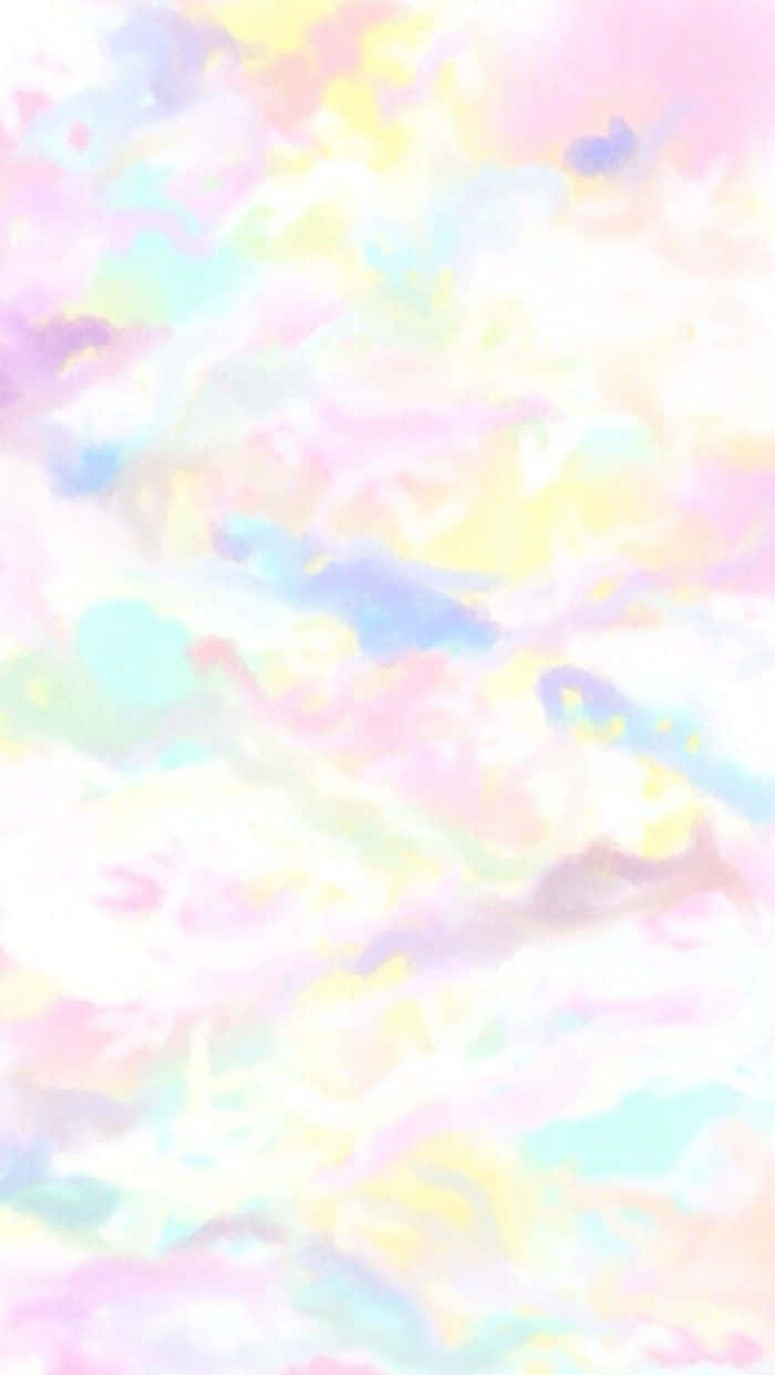 Watercolor 桌布 壁紙 — 柔和的粉彩雲朵在粉紅、黃色和薄荷色的溫柔漸變中旋轉，營造出夢幻空靈的天空。