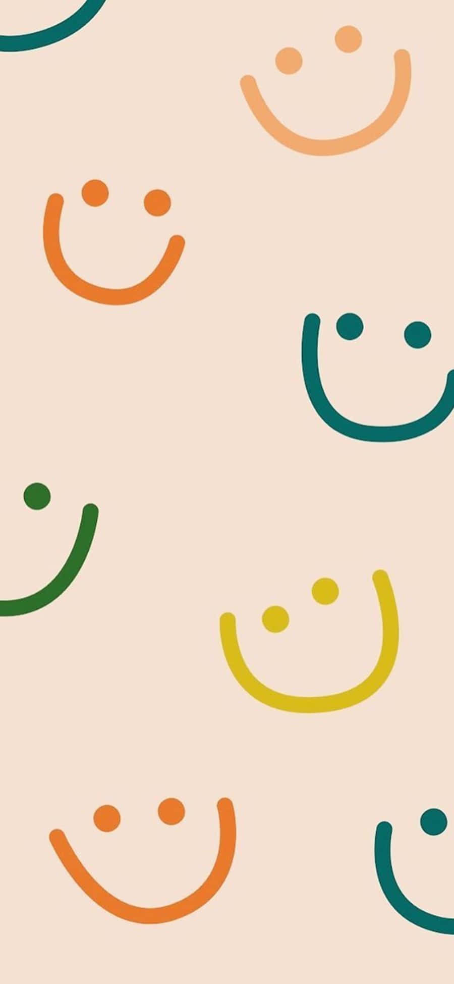 Aesthetic Smiley Face 桌布 壁紙 — 柔和粉彩背景上散落著橙色、綠色和黃色的彩色極簡笑臉。