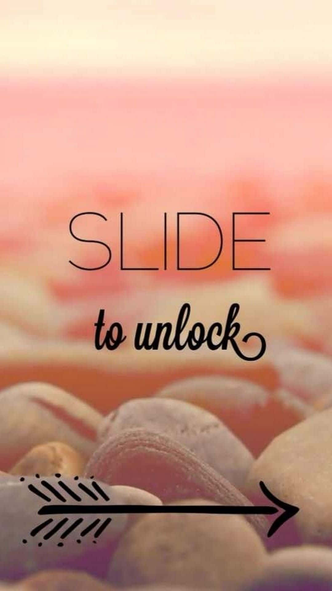 美學 桌布 壁紙 — 柔和粉紅與蜜桃漸變背景，帶有「SLIDE to unlock」文字和箭頭，置於模糊卵石上。