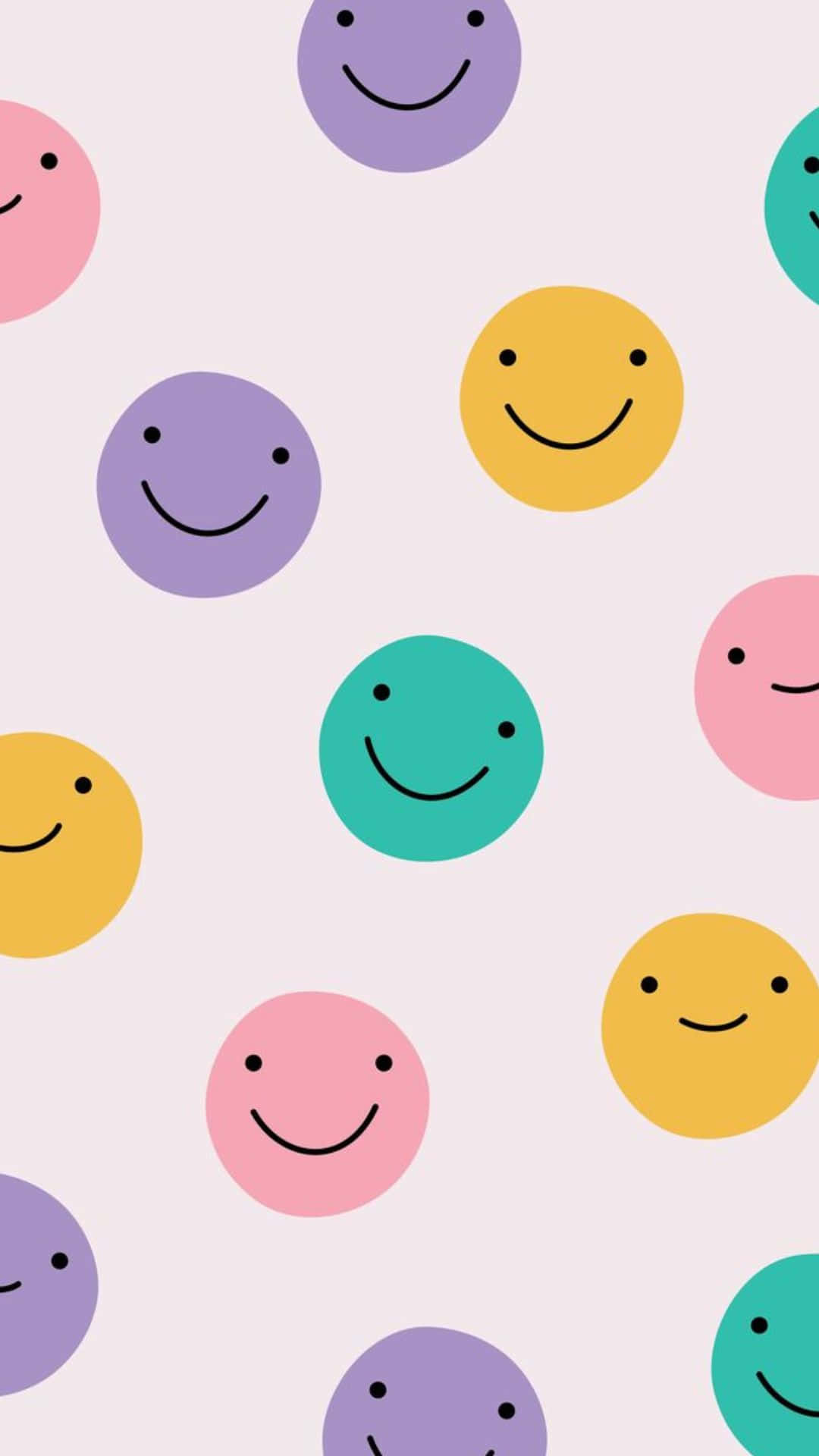Kawaii Emoticon 桌布 壁紙 — 柔和粉紅色背景上，飄浮著粉彩色的笑臉，形成一個俏皮散落的圖案。