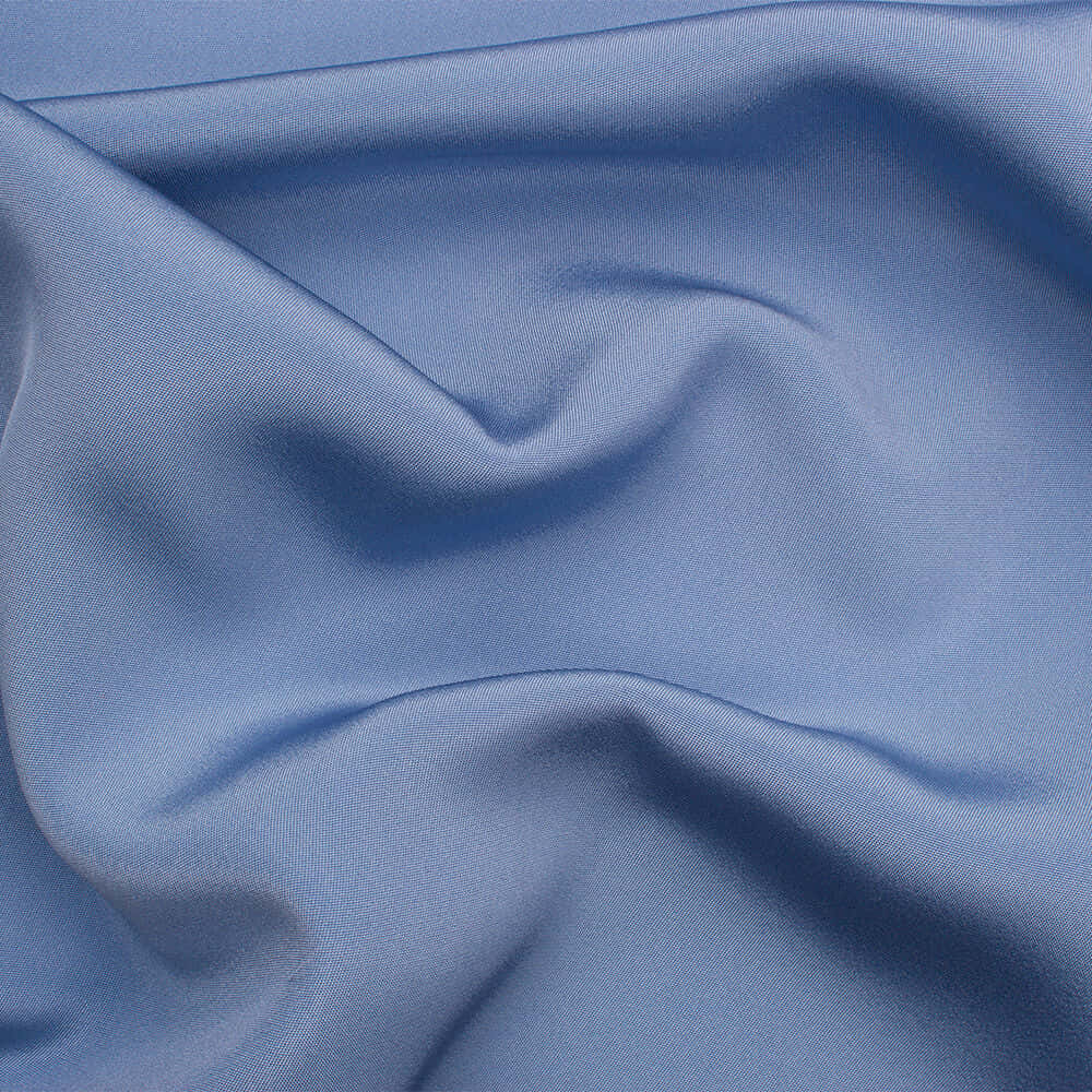 Periwinkle Blue 桌布 壁紙 — 柔和藍色布料的特寫，帶有輕柔的摺痕和細微紋理，光線均勻。