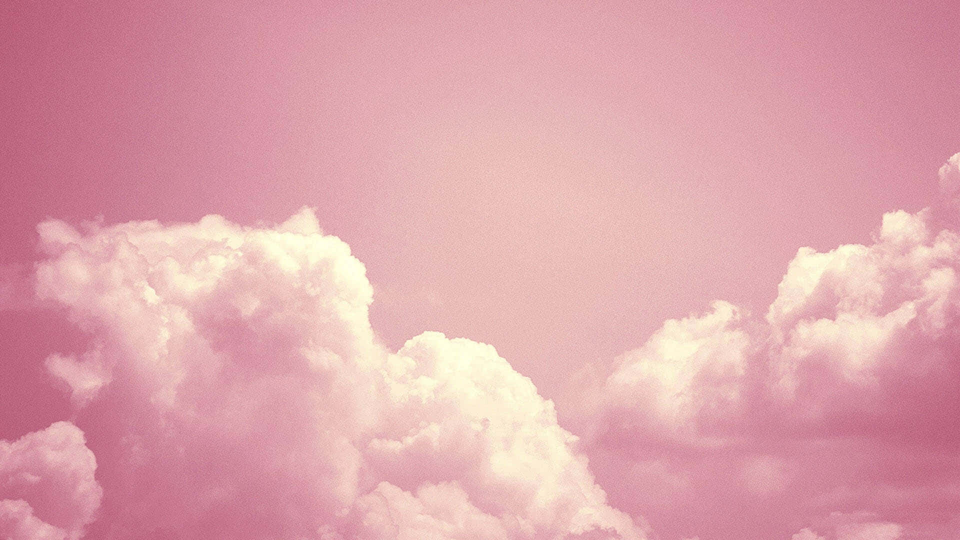 雲朵 桌布 壁紙 — 柔軟如棉的雲朵在夢幻的粉紅天空中飄移，營造出寧靜而空靈的氛圍。