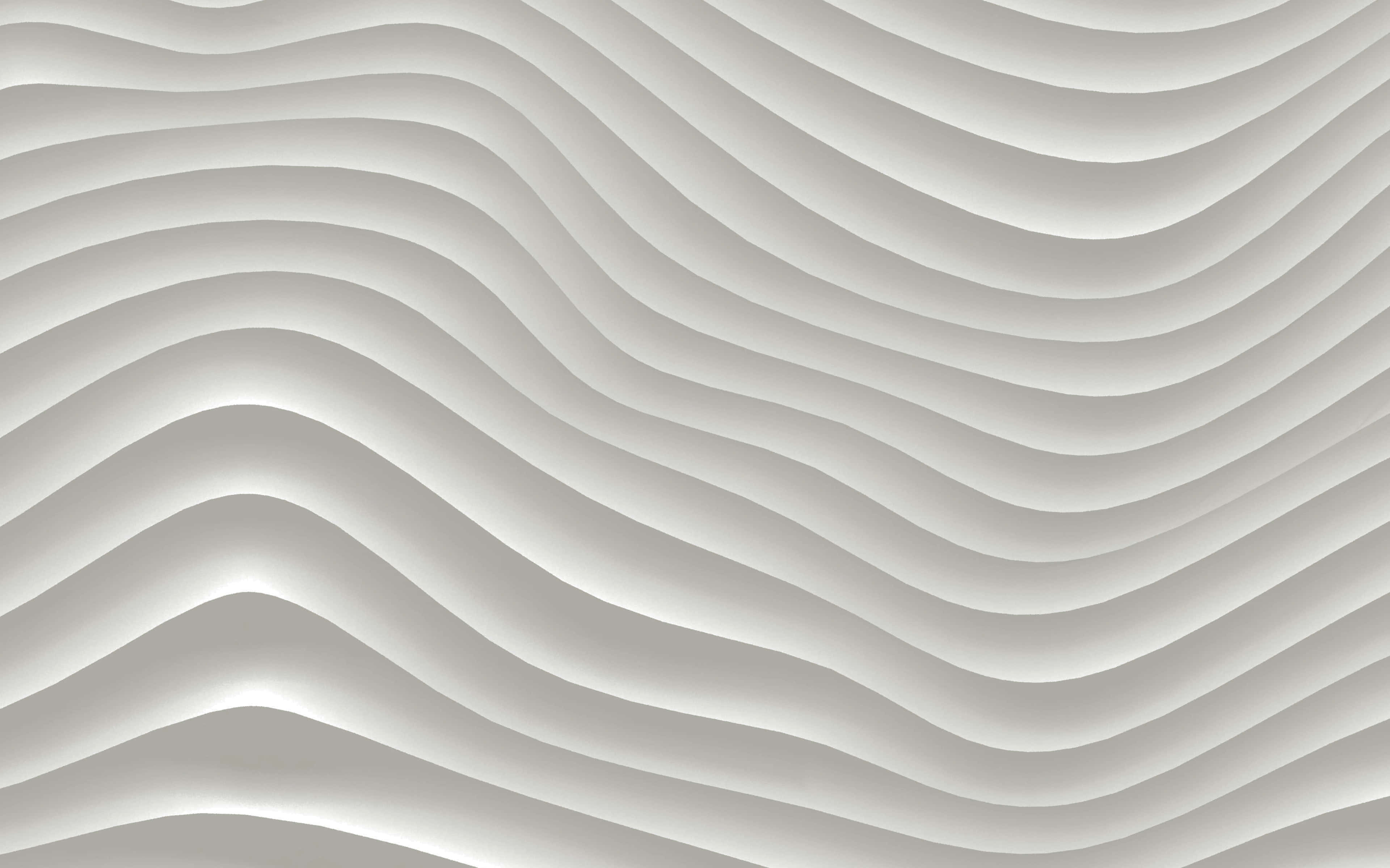 Wavy Lines 桌布 壁紙 — 柔軟灰色平滑起伏的波浪，營造出帶有柔和陰影與高光的寧靜抽象圖案。