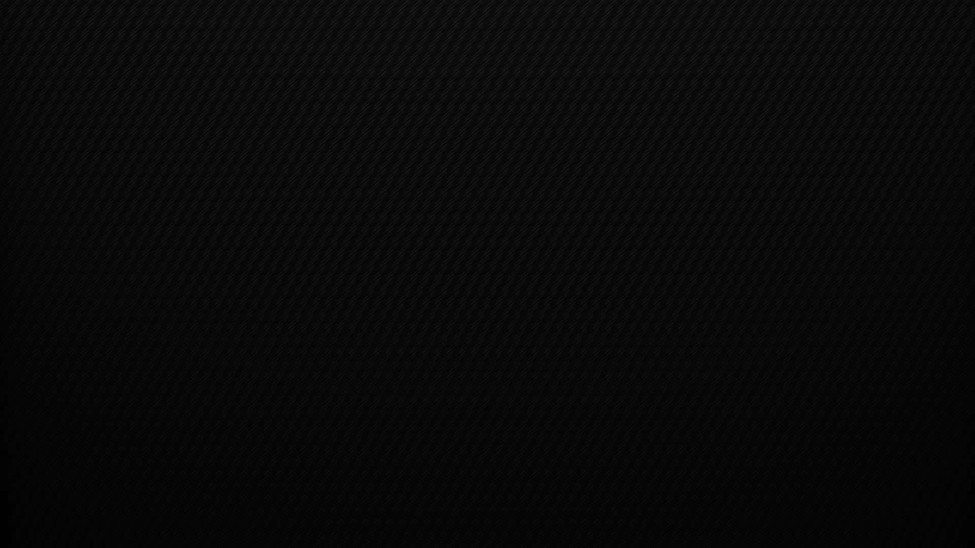 Plain Black Desktop 桌布 壁紙 — 柔軟燈光下帶有斜紋編織圖案的時尚黑色碳纖維紋理。