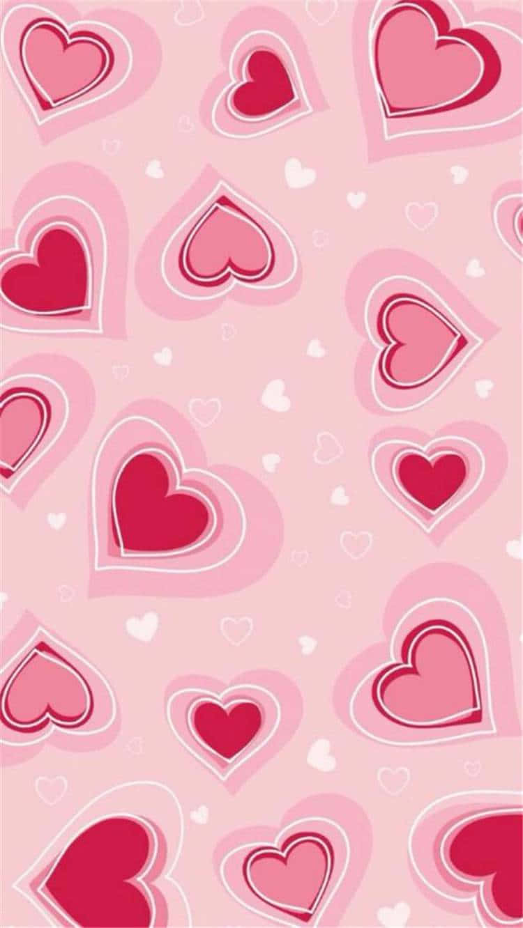 Cute Valentines 桌布 壁紙 — 柔軟的粉紅色壁紙，上面有不同大小的紅色和白色愛心層層疊疊，營造出甜美浪漫的圖案。