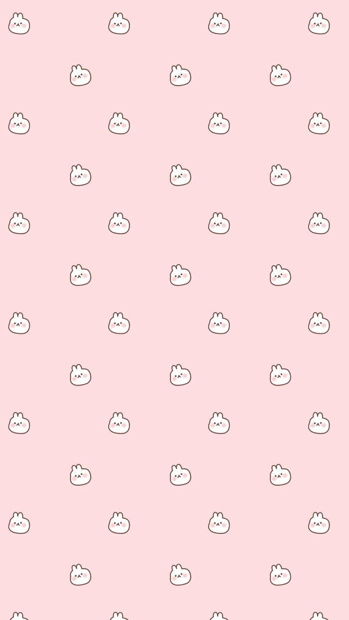 girly pink aesthetic 桌布 壁紙 — 柔軟的粉紅色壁紙，帶有重複的可愛白色卡通兔子圖案，配有簡單的黑色輪廓。