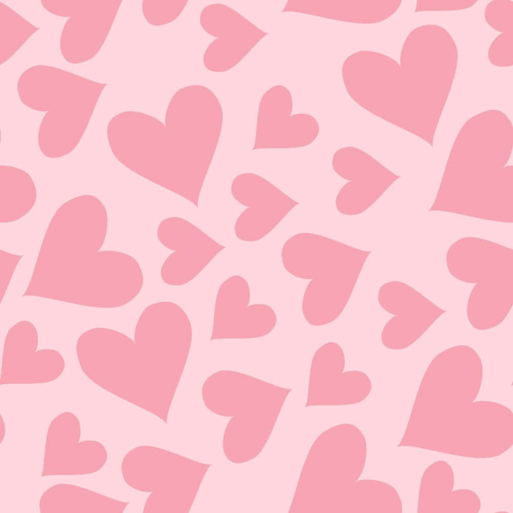 Heart Pattern 桌布 壁紙 — 柔軟的粉紅色壁紙圖案，散落著不同大小和方向的心形。