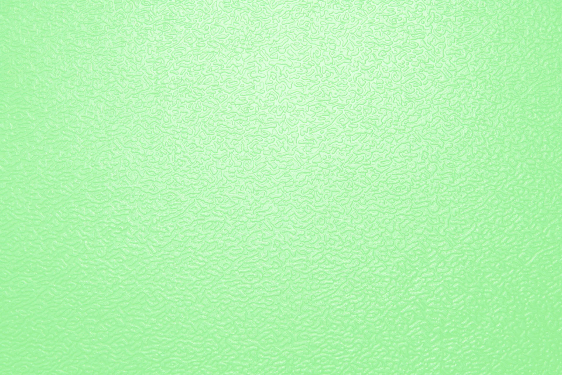 Textured 桌布 壁紙 — 柔軟的薄荷綠色紋理表面，帶有微妙的漩渦圖案和柔和的漸變效果。