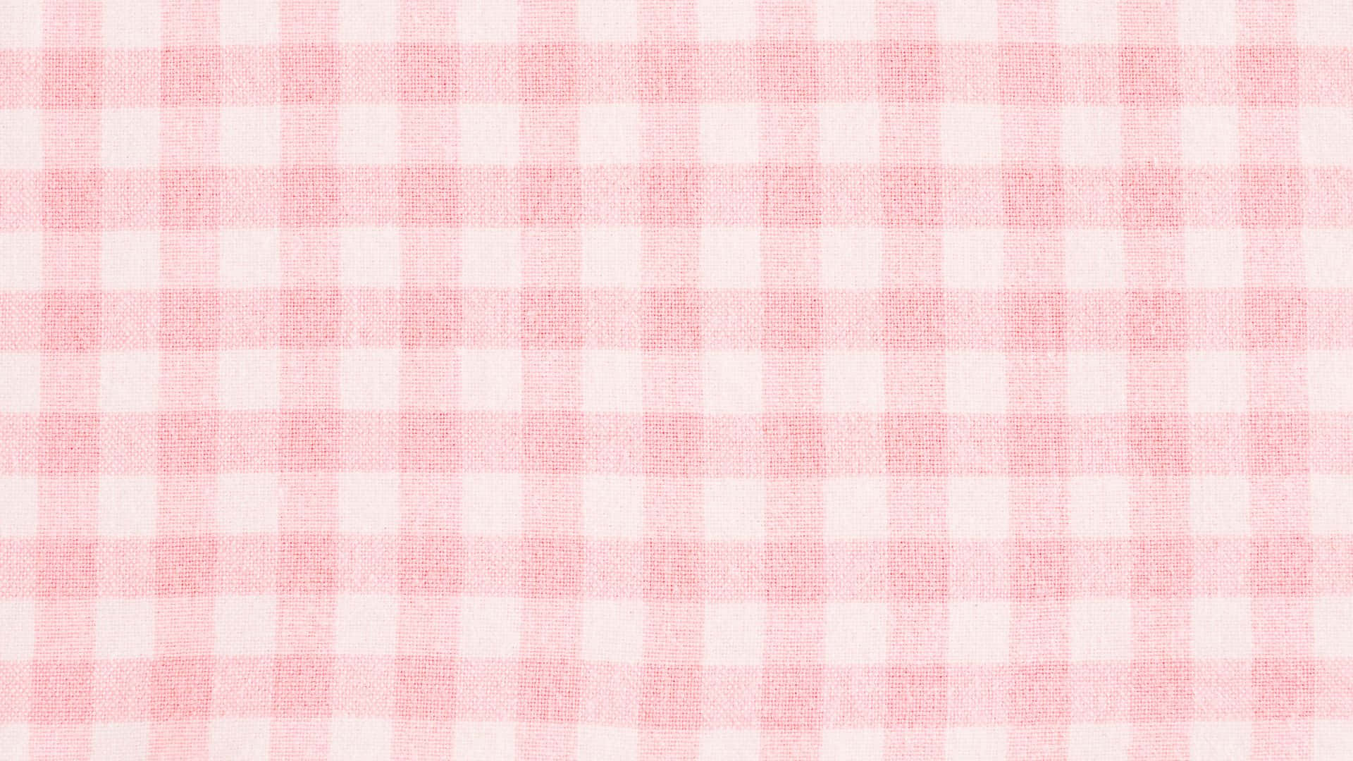Pink Checkered 桌布 壁紙 — 柔軟粉紅白色格紋布料的特寫，可見編織紋理和均勻的網格圖案。