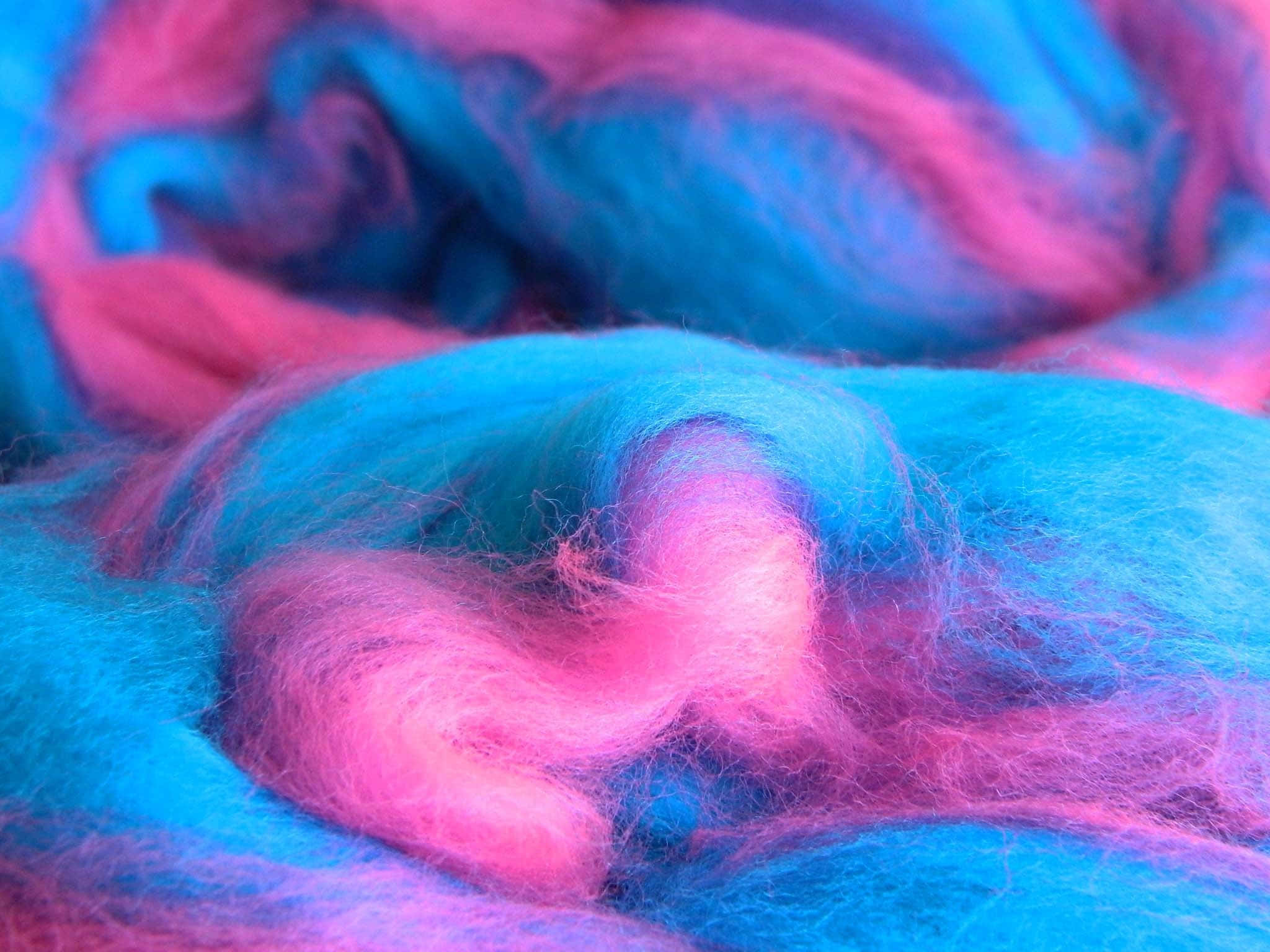 Pink Cotton Candy 桌布 壁紙 — 柔軟蓬鬆的纖維以鮮豔的粉紅色和藍色混合在一起，形成夢幻般的特寫紋理。