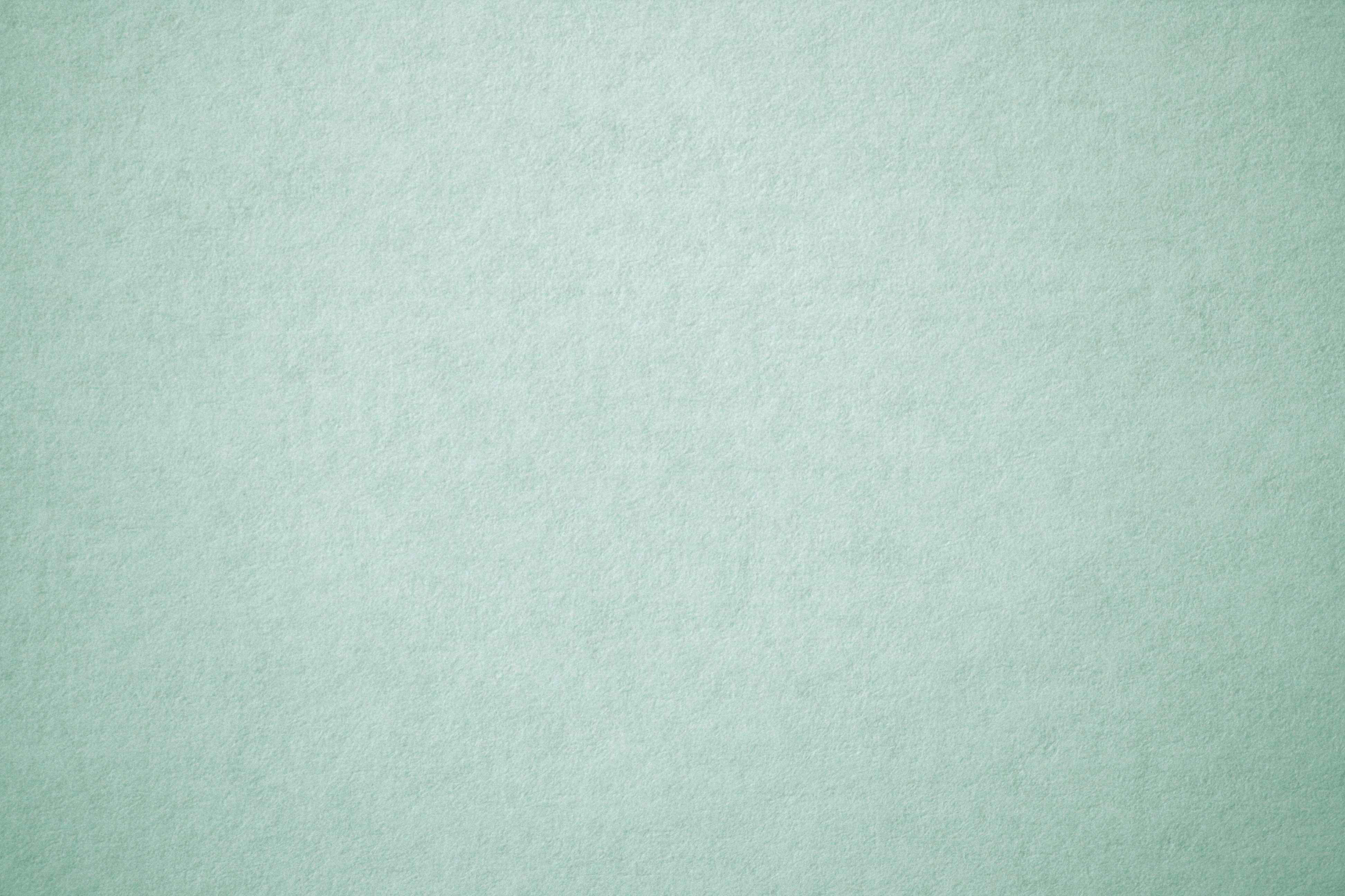Sage 桌布 壁紙 — 柔軟薄荷綠色紋理紙張表面的特寫，帶有細微紋理和均勻照明。