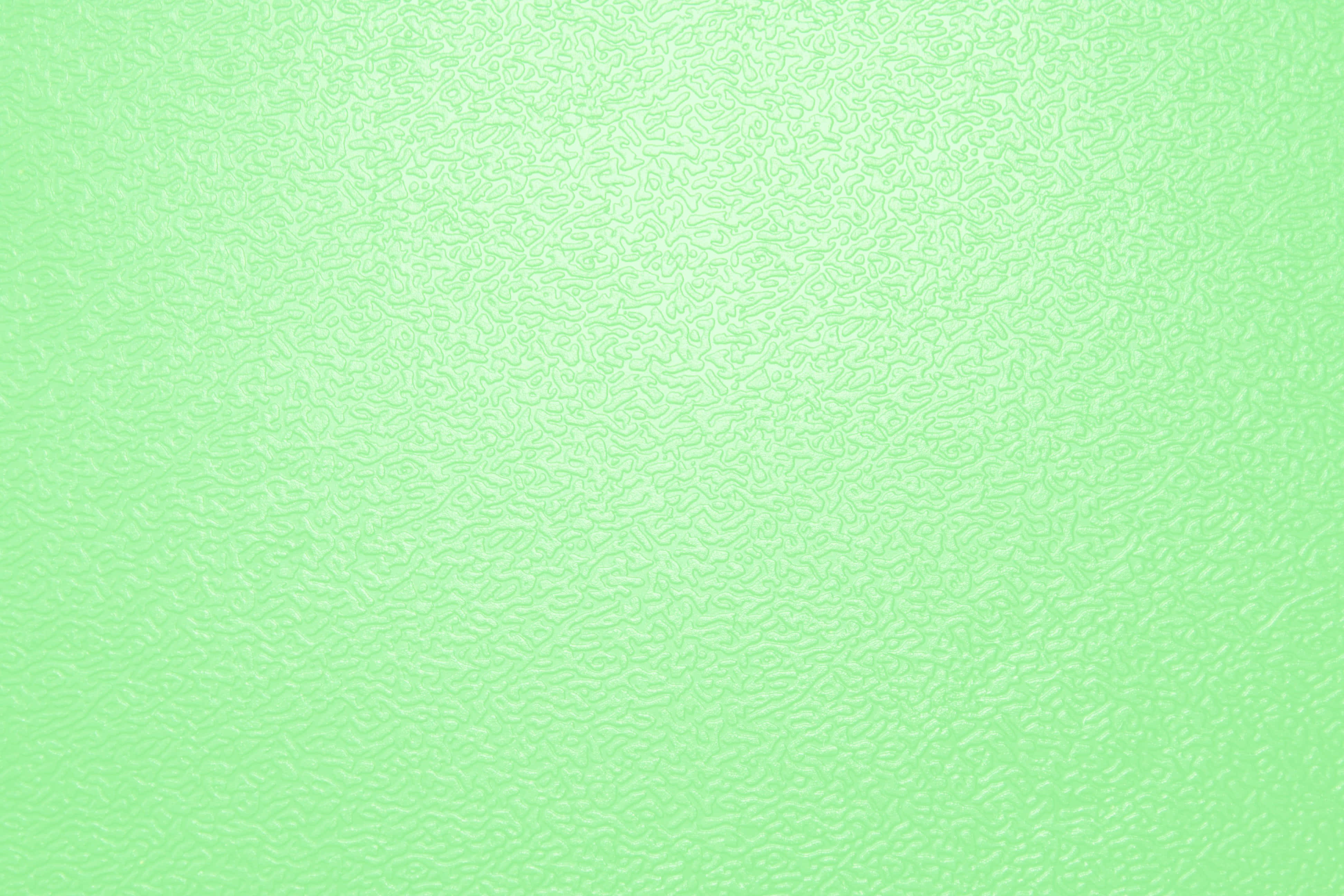 Green Texture 桌布 壁紙 — 柔軟薄荷綠色紋理表面，帶有細微波浪圖案及從中心到邊緣的柔和漸變。