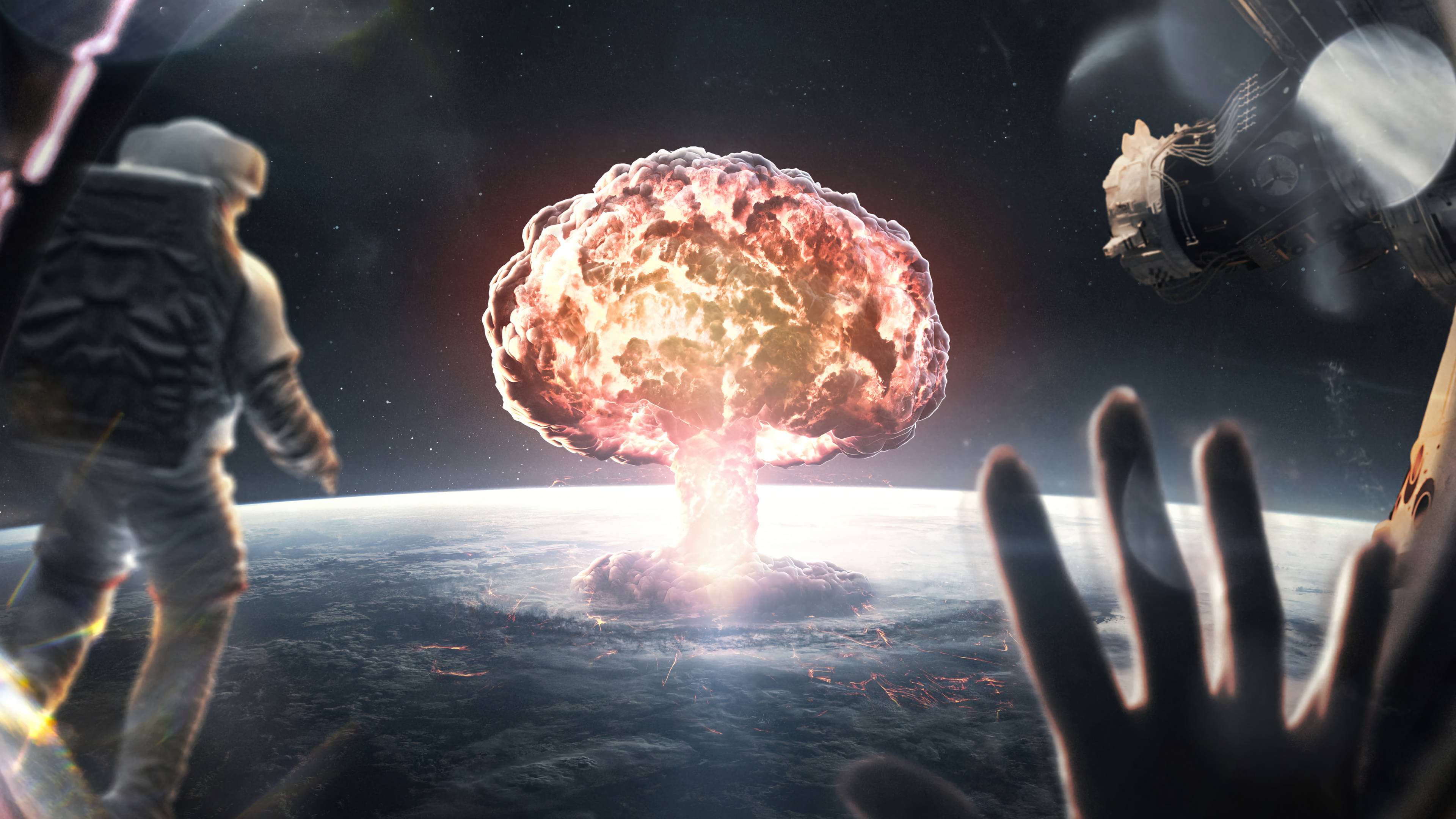 桌布 壁紙 — 核爆炸在地球上空綻放，一名太空人和一隻手伸向太空中熾熱的蘑菇雲。