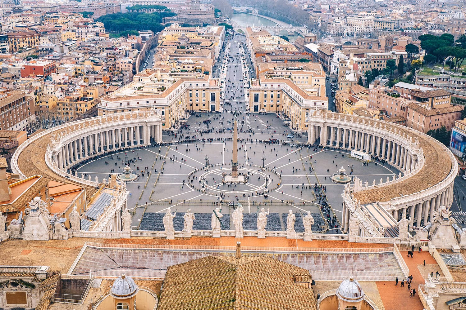 Rome 桌布 壁紙 — 梵蒂岡城聖彼得廣場的鳥瞰圖，柱廊向外輻射，人群聚集在中央方尖碑周圍。