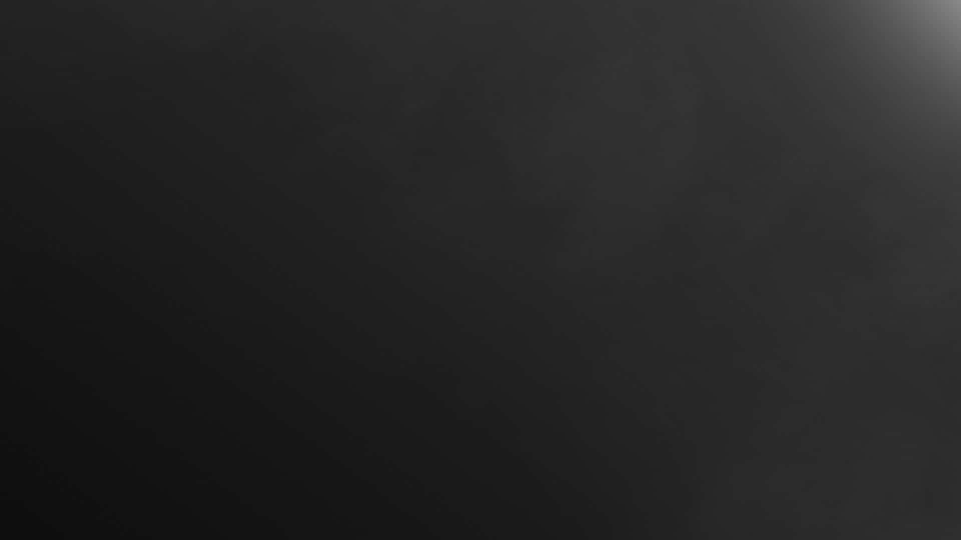 Dark Minimalist 桌布 壁紙 — 極簡深灰色漸變背景，帶有細微紋理和從右上角漸弱的柔和光線。