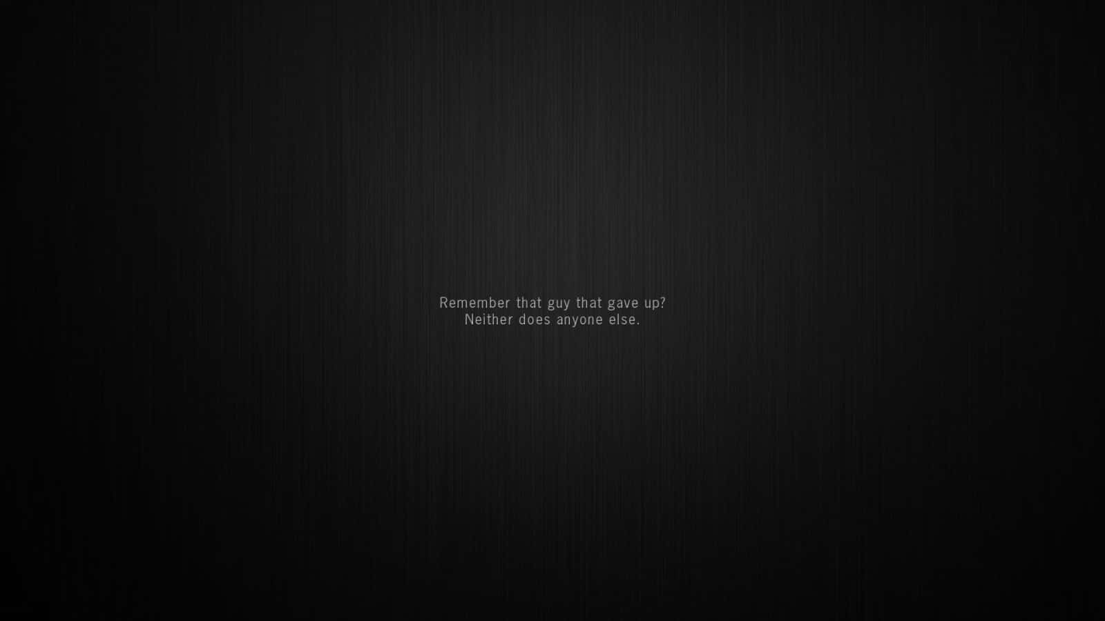 Motivational Quotes Black 桌布 壁紙 — 極簡深色紋理背景，中央帶有微弱的白色勵志文字。