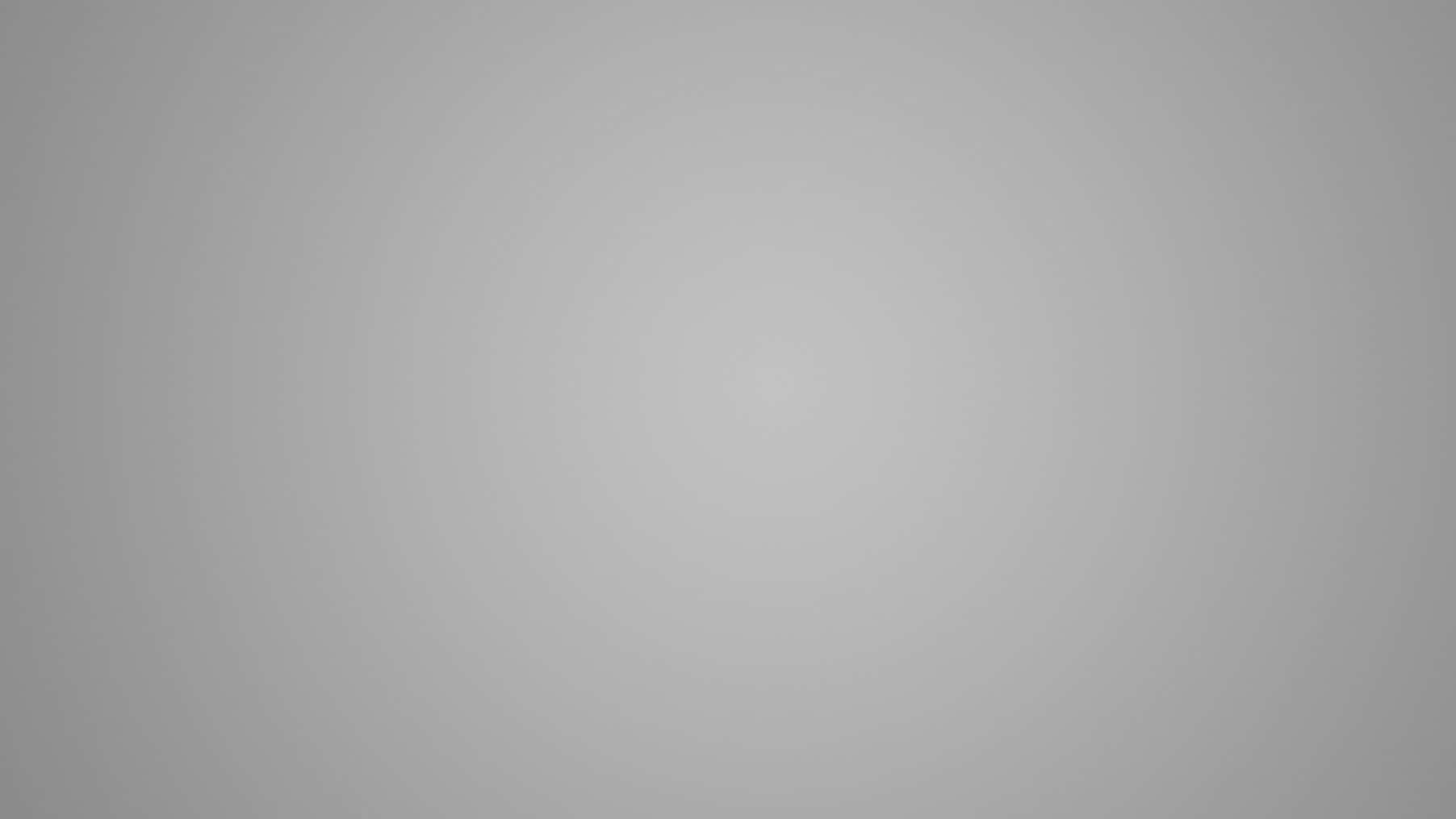 Grey Gradient 桌布 壁紙 — 極簡漸變灰色背景，帶有從中心向外漸弱的柔和放射狀光線。