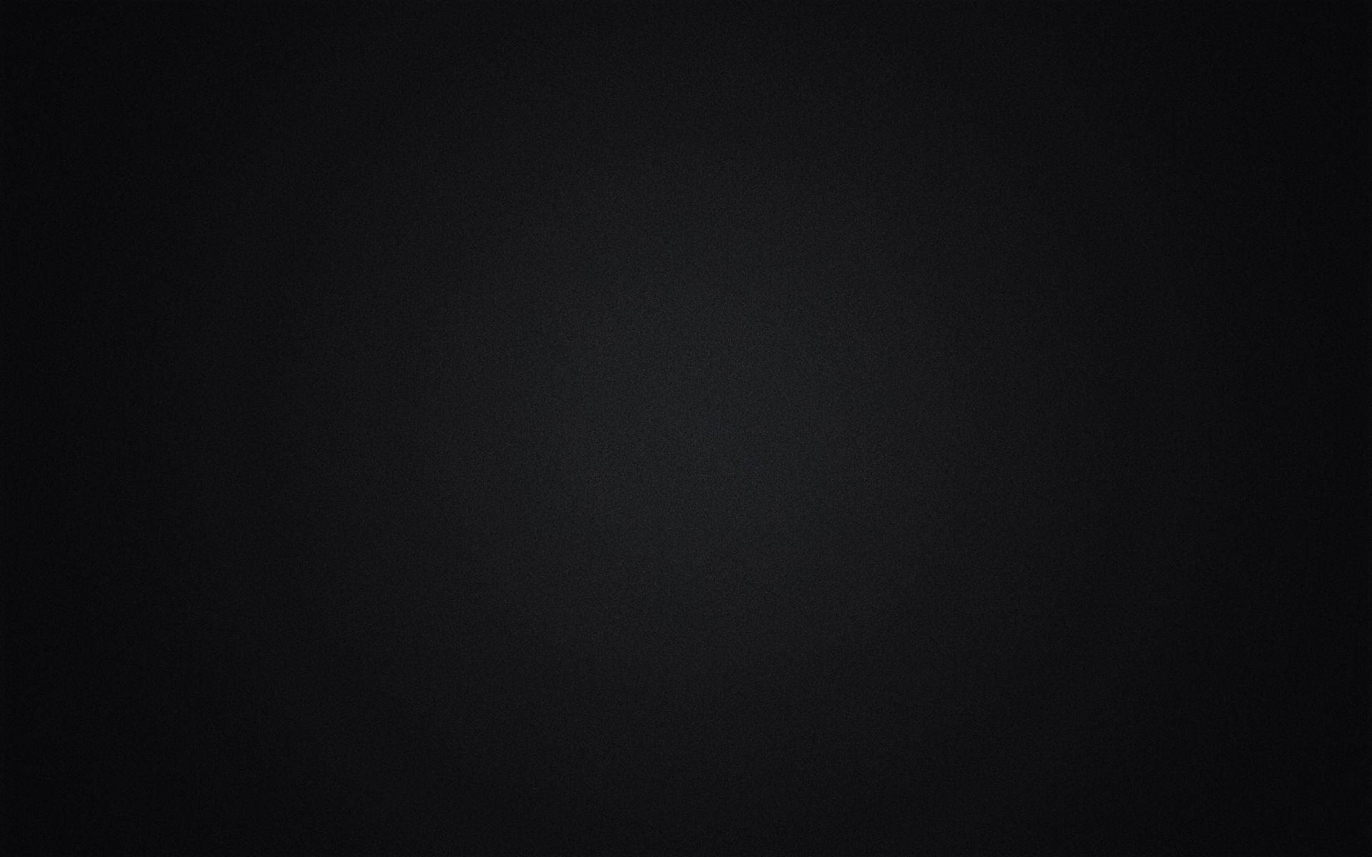黑色美學 桌布 壁紙 — 極簡漸變黑色背景，帶有細微紋理，柔和光線從中心向邊緣漸淡。