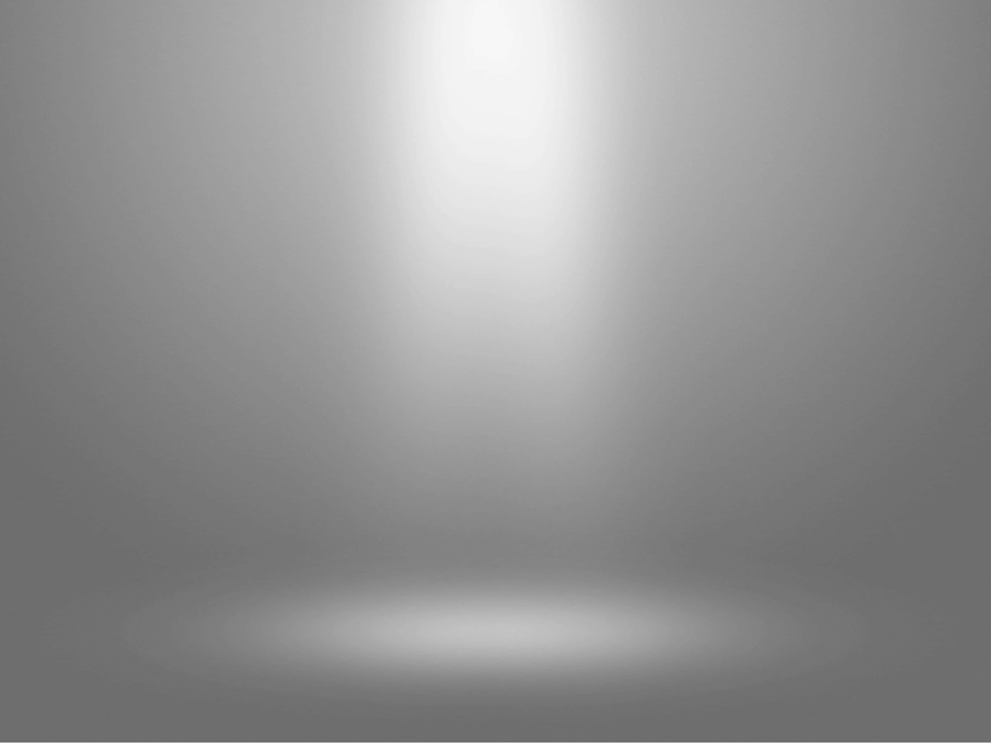 Spotlight 桌布 壁紙 — 極簡灰色漸變背景，帶有柔和聚光燈效果，在地板上形成發光的圓形亮點。