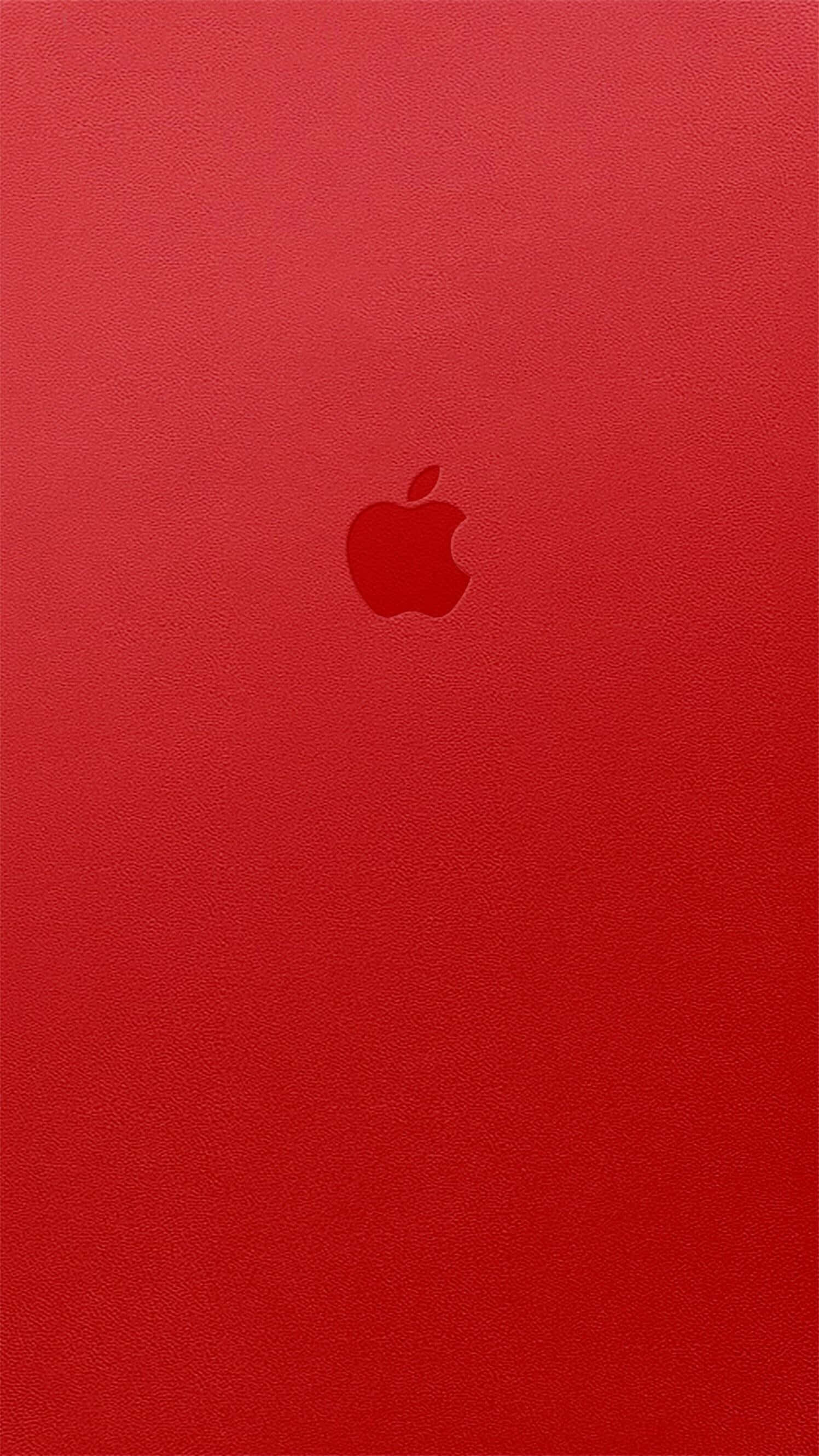 桌布 壁紙 — 極簡紅色皮革紋理壁紙，中央帶有微妙的Apple標誌。