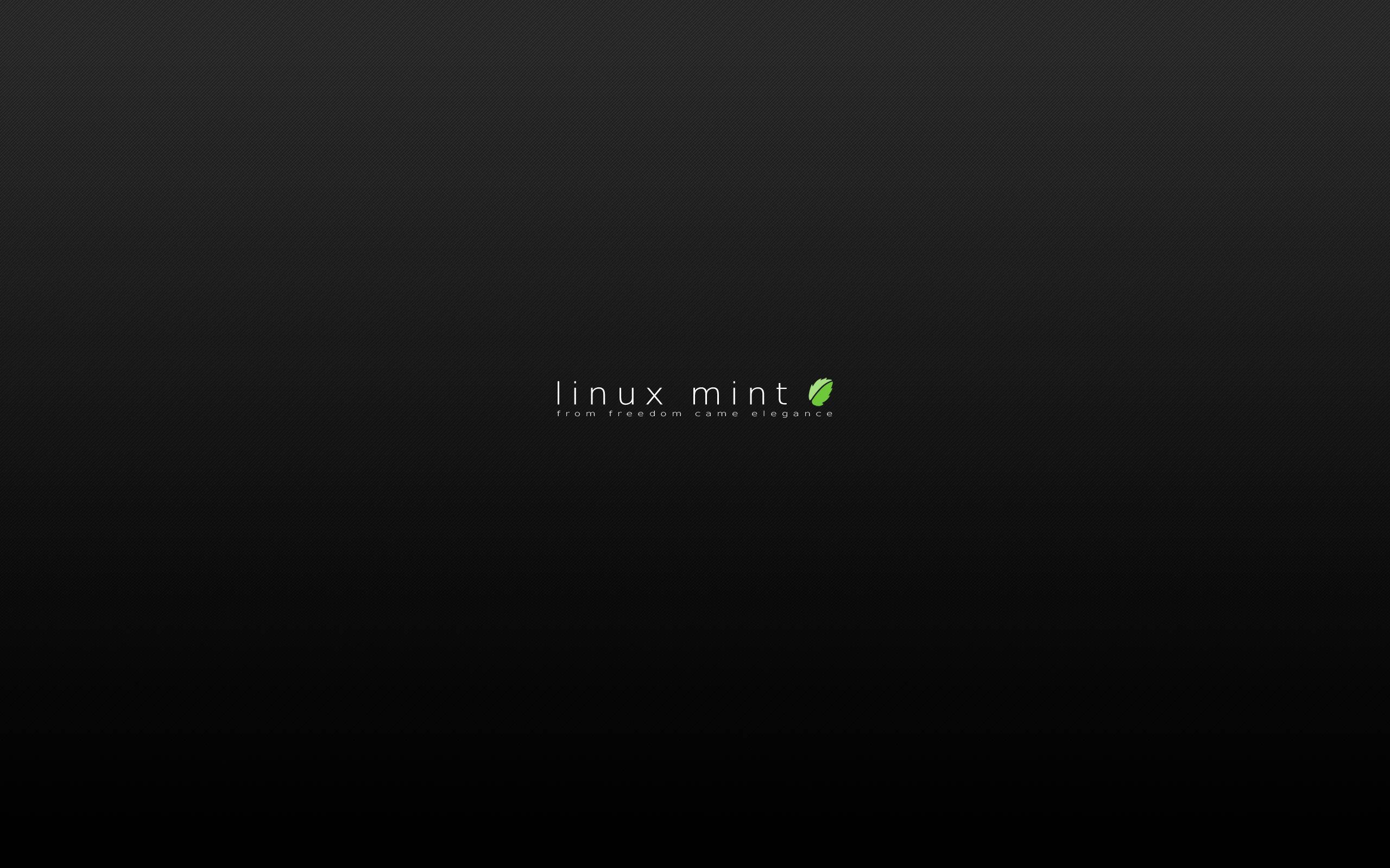 Linux 桌布 壁紙 — 極簡黑色桌布，中央以清晰白色和綠色文字顯示 Linux Mint 標誌和標語。
