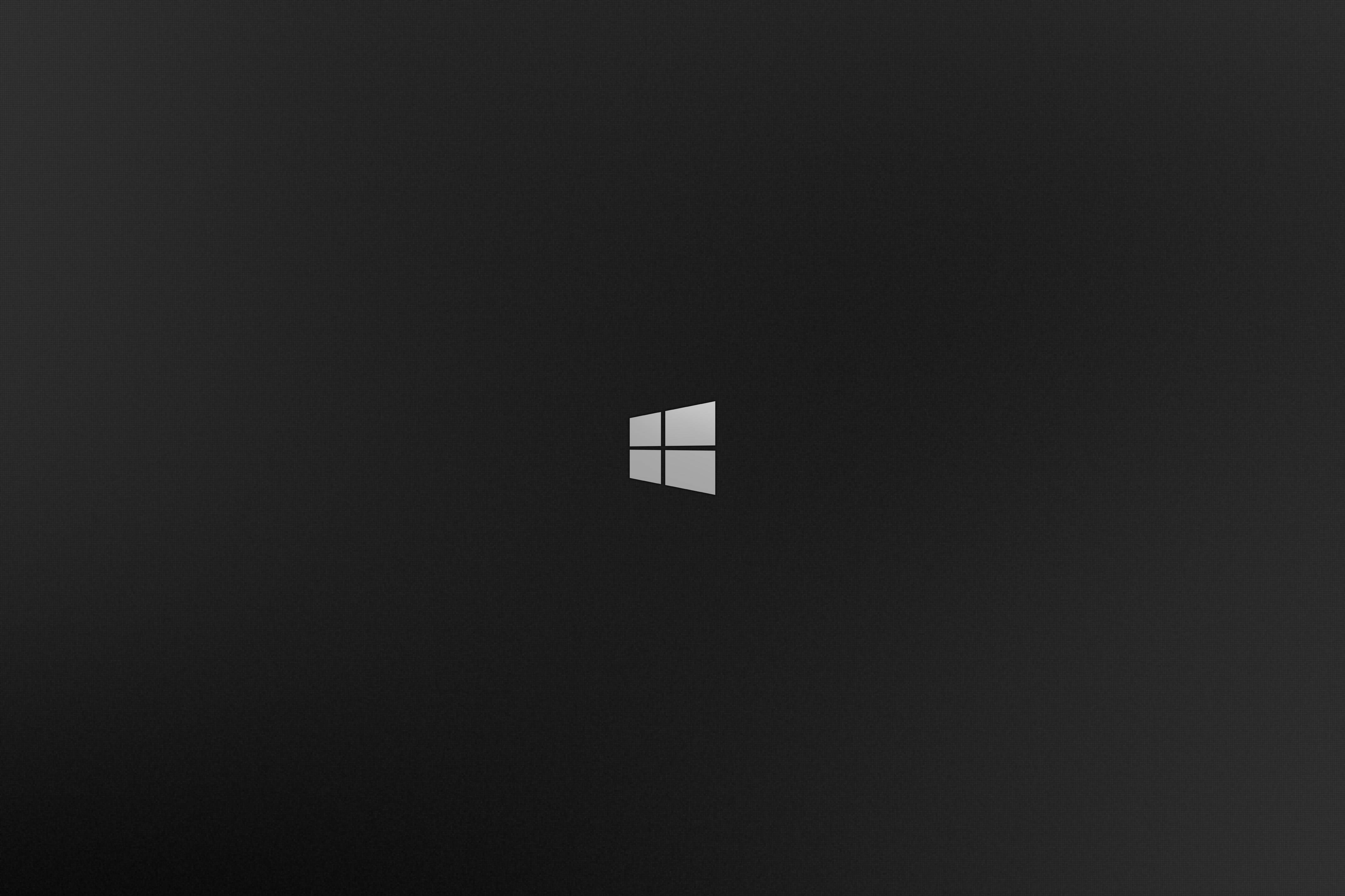 Dark Windows 桌布 壁紙 — 極簡黑色桌布，中央帶有銀色Windows標誌，背景帶有微妙的漸變效果。