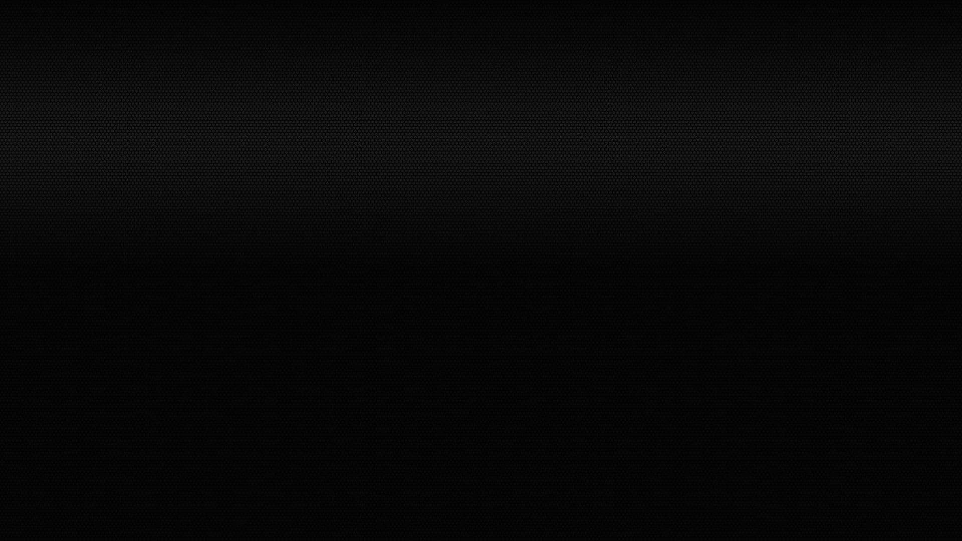 Black Solid 桌布 壁紙 — 極簡黑色背景，帶有細微漸變和精細點狀紋理。