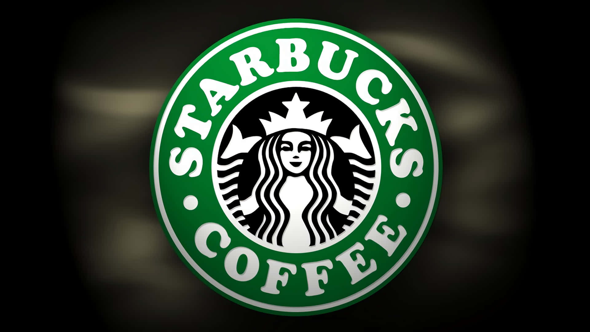 星巴克 桌布 壁紙 — 標誌性的Starbucks標誌在黑暗模糊的背景上發出鮮豔的綠色光芒。