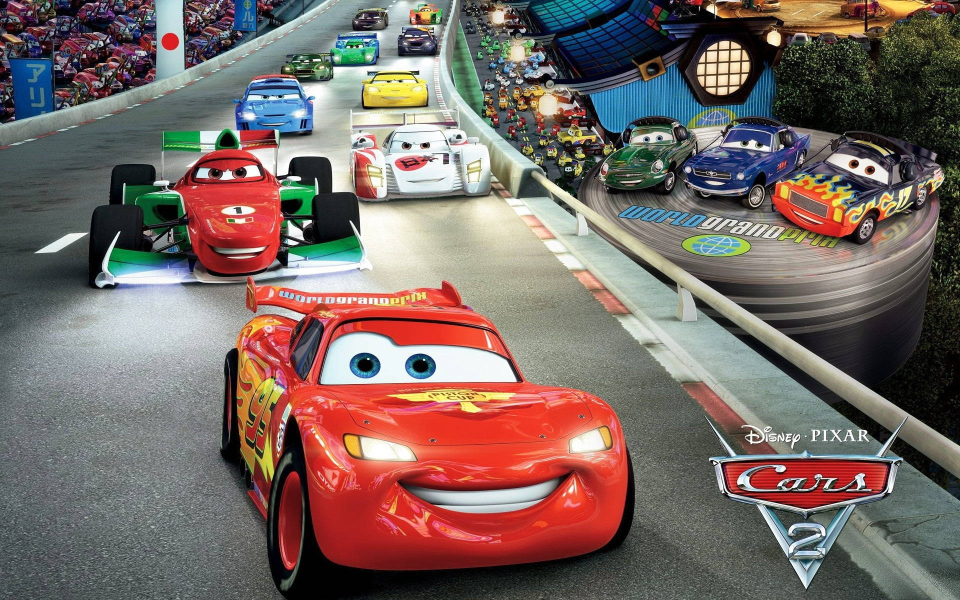 Road 桌布 壁紙 — 《汽車總動員2》中充滿活力的動畫賽車場景，閃電麥坤帶領一群色彩繽紛的擬人化賽車在蜿蜒的賽道上奔馳。