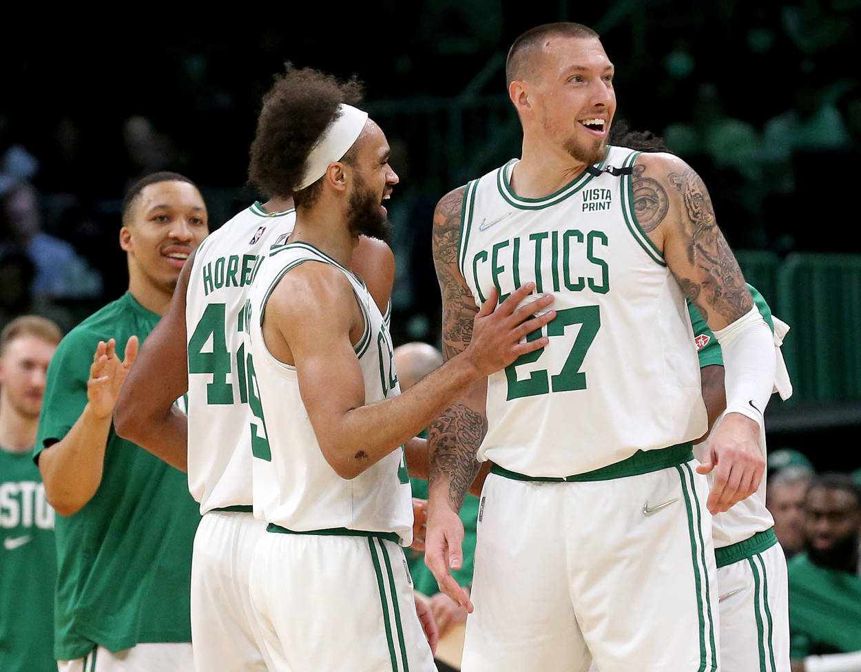 NBA 桌布 壁紙 — 波士頓塞爾提克籃球球員在比賽中以白色和綠色球衣慶祝，背景可見刺青和人群。