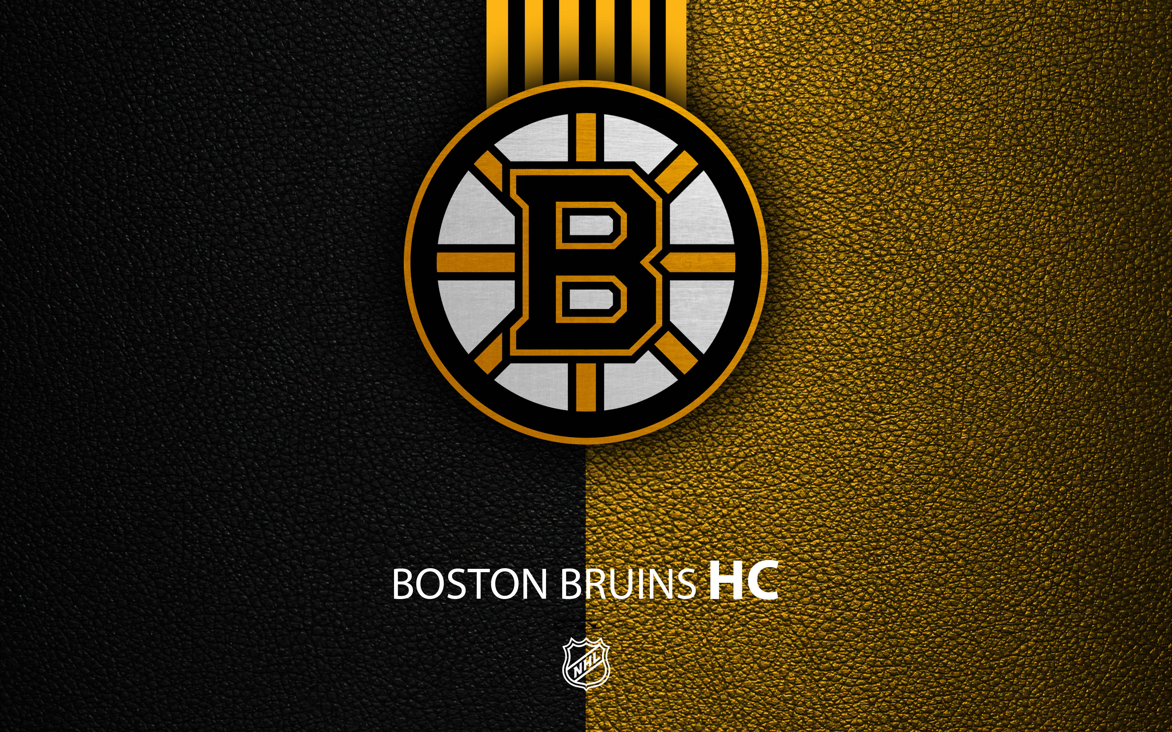 bruins 桌布 壁紙 — 波士頓棕熊冰球隊標誌居中，置於黑色和金色皮革紋理分割背景上，下方有球隊名稱。