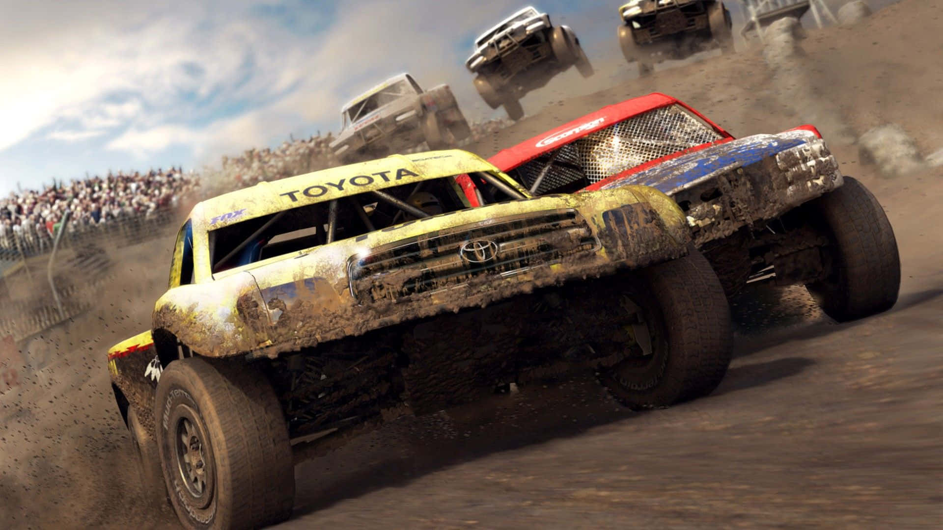 Racing Games 桌布 壁紙 — 泥濘的怪獸卡車在高速碰撞中飛越泥地賽道，背景有觀眾歡呼。