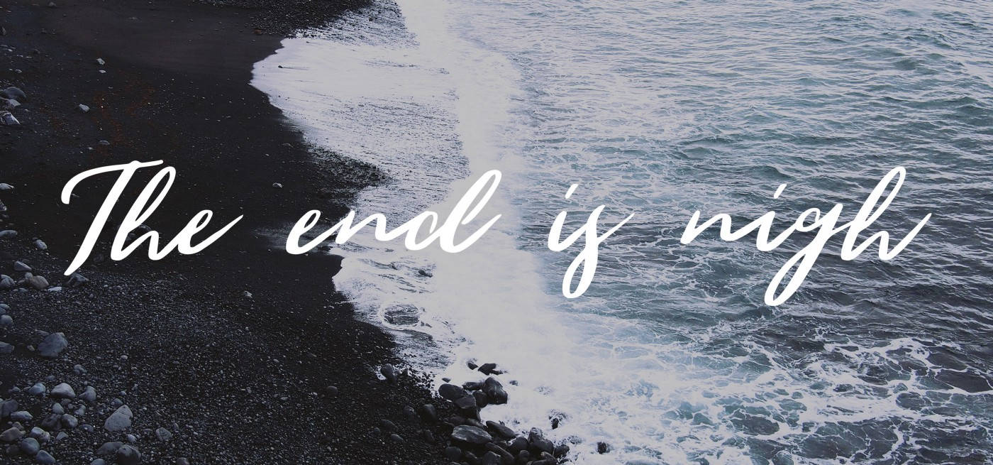 黑暗的火山海灘，海浪拍打，白色草書文字寫著「The end is nigh」。
